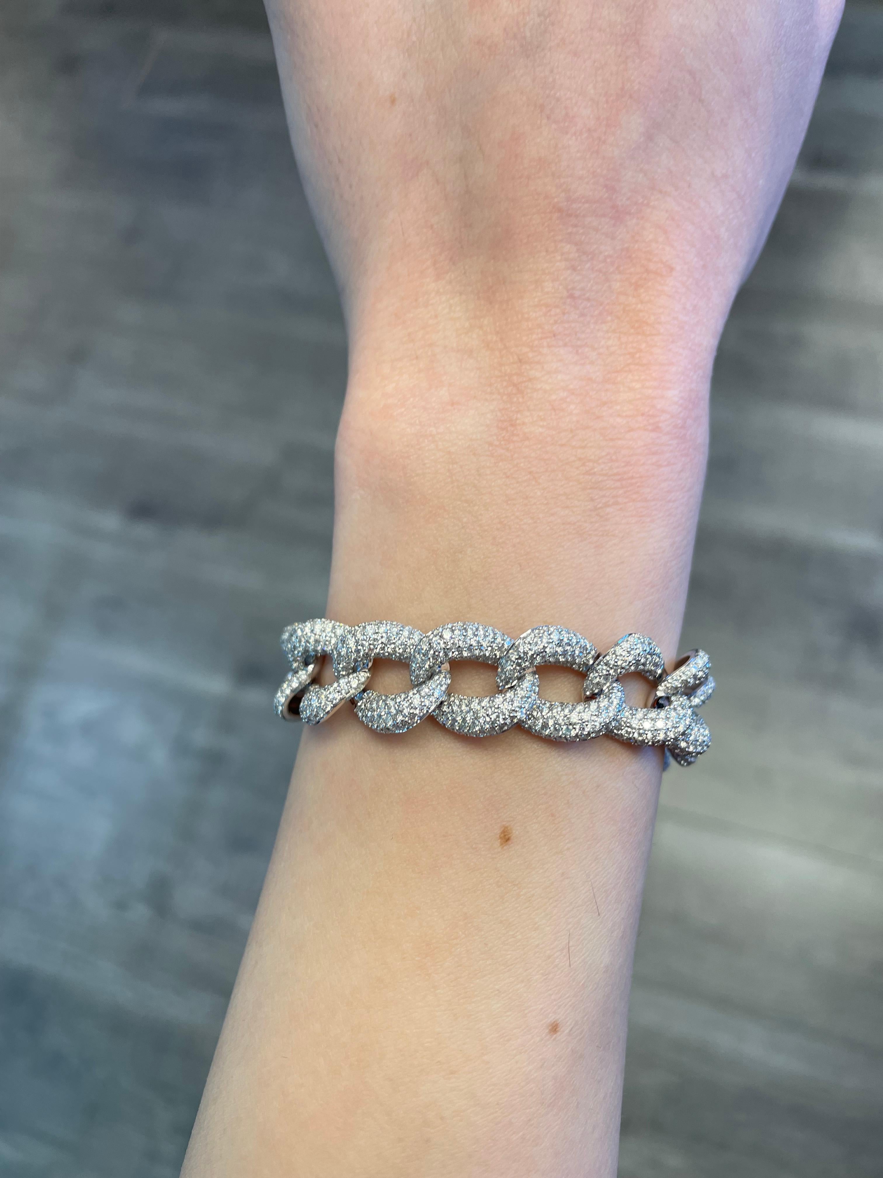 Modern diamond cuban link bracelet. High jewelry by Alexander Beverly Hills.
1648 round brilliant diamonds, 12.27carats total. Approximately G/H color and VS2/SI1 clarity. 18k white gold, 49.40 grams, and 14mm width.
Accommodated with an up-to-date