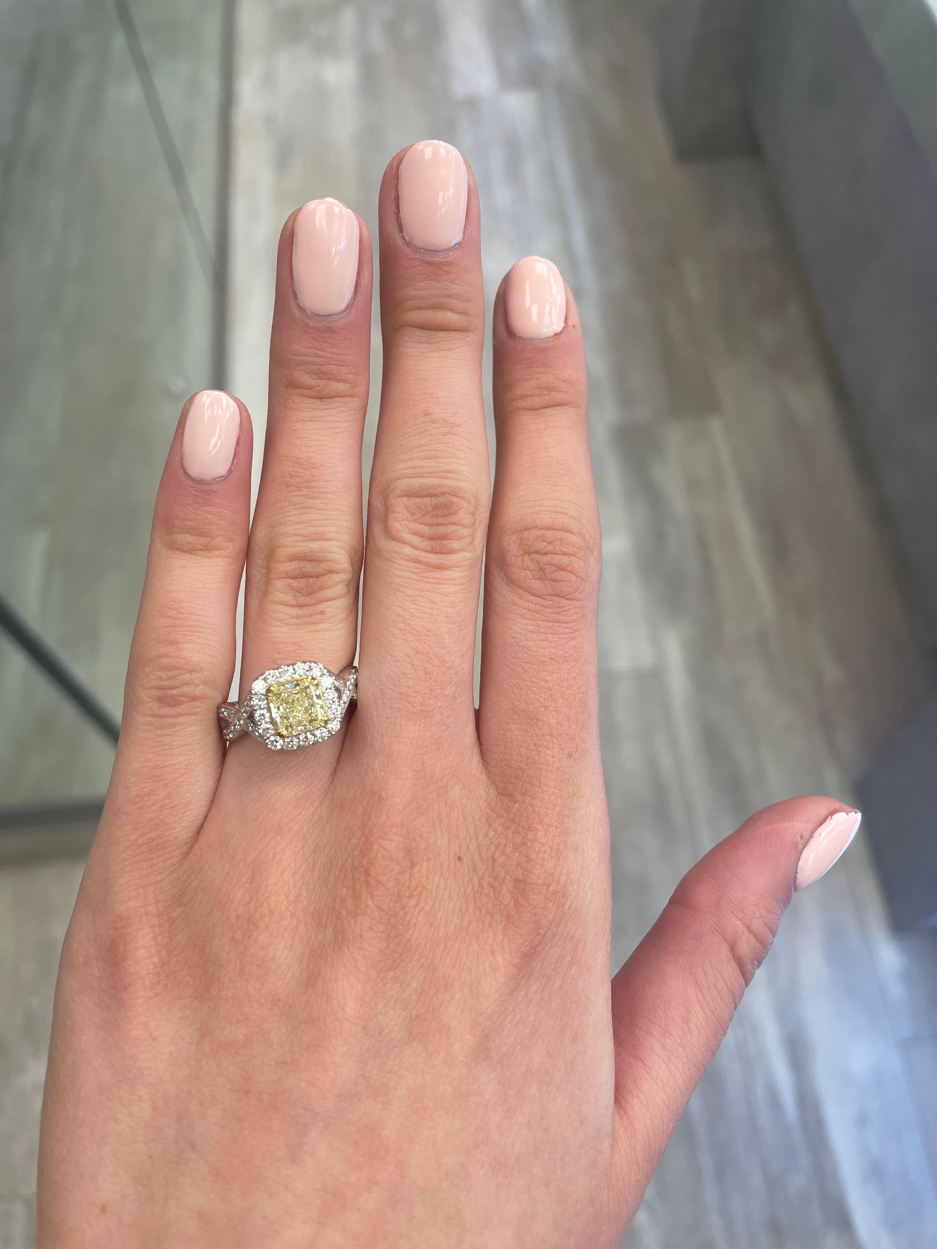 Stunning modern EGL certified yellow diamond with halo ring, two-tone 18k yellow and white gold, twisted shank. By Alexander Beverly Hills
2.03 carats total diamond weight.
1.25 carat radiant cut Fancy Intense Yellow color and VS1 clarity diamond,