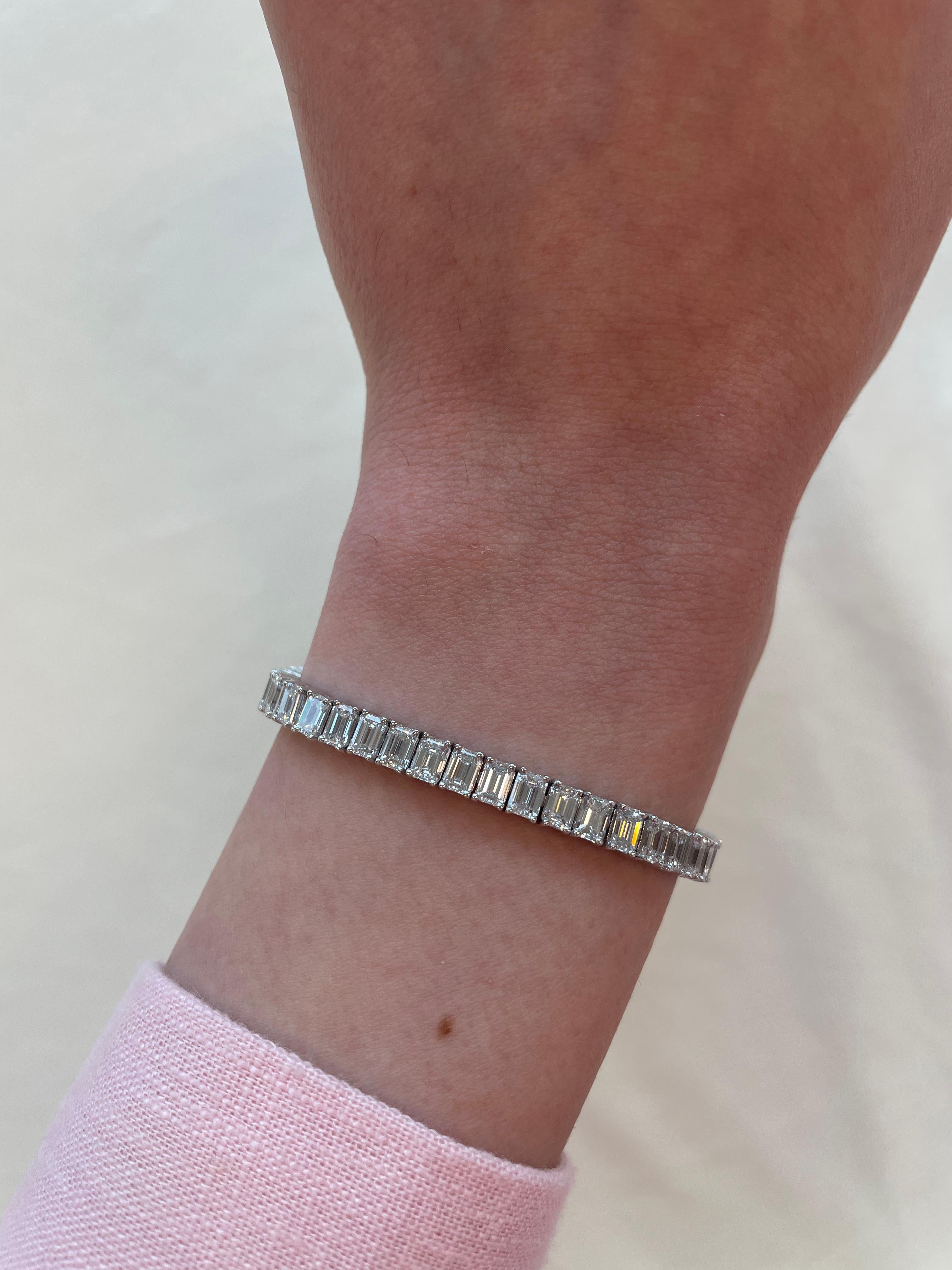 Stunning modern straight emerald cut diamond tennis bracelet. High jewelry by Alexander Beverly Hills.
52 emerald cut diamonds, 12.65 carats. Approximately F/G color and VVS clarity. 18k white gold, 18.16 grams, 7 inches.
Accommodated with an up to