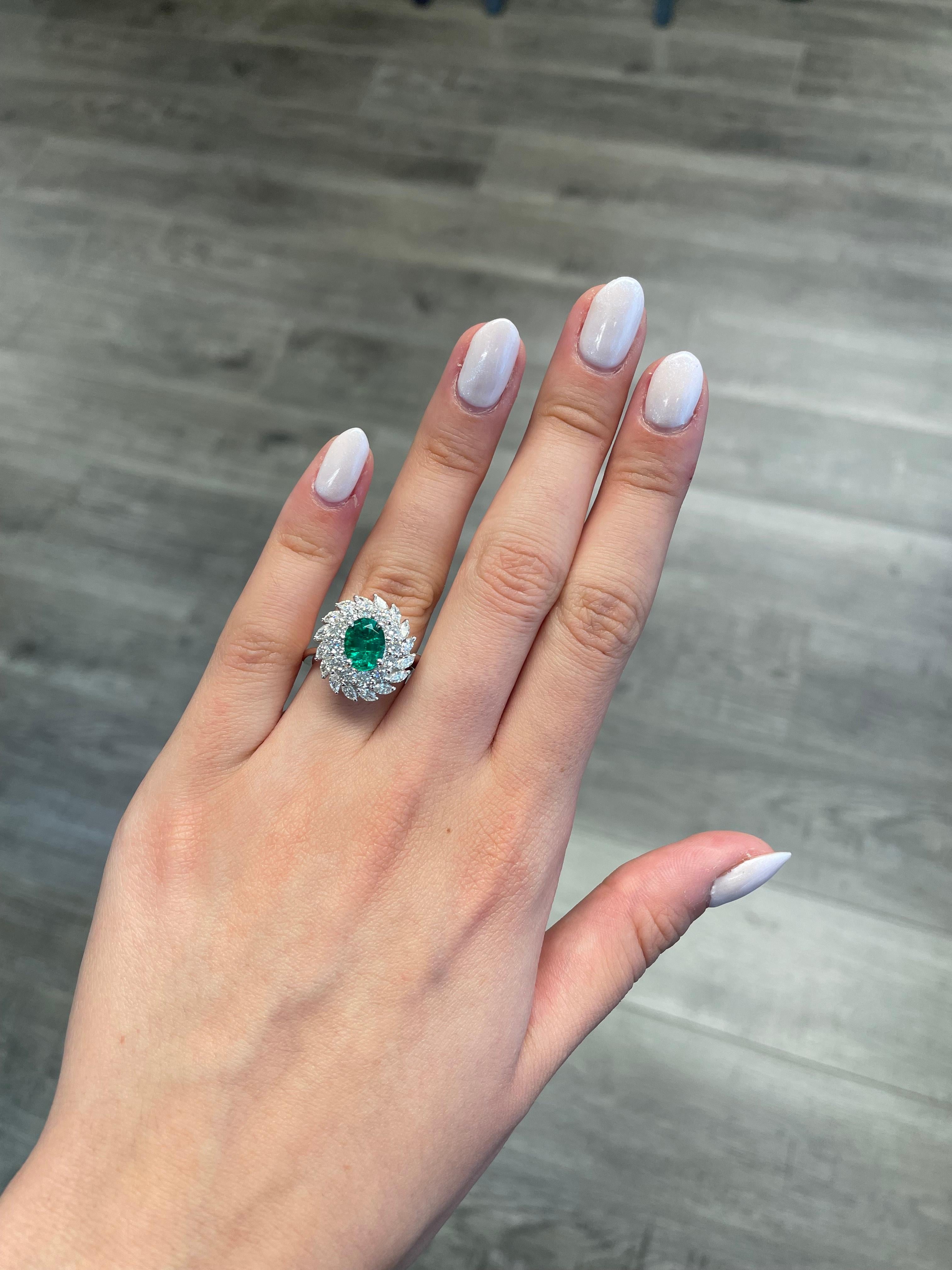 Lovely emerald with diamond double halo ring. By Alexander Beverly Hills.
1.30 carat oval emerald apx F2 complemented with round and marquise brilliant diamonds, 1.48ct. Approximately H/I color and SI clarity. 2.78ct total gemstone weight, in 18k