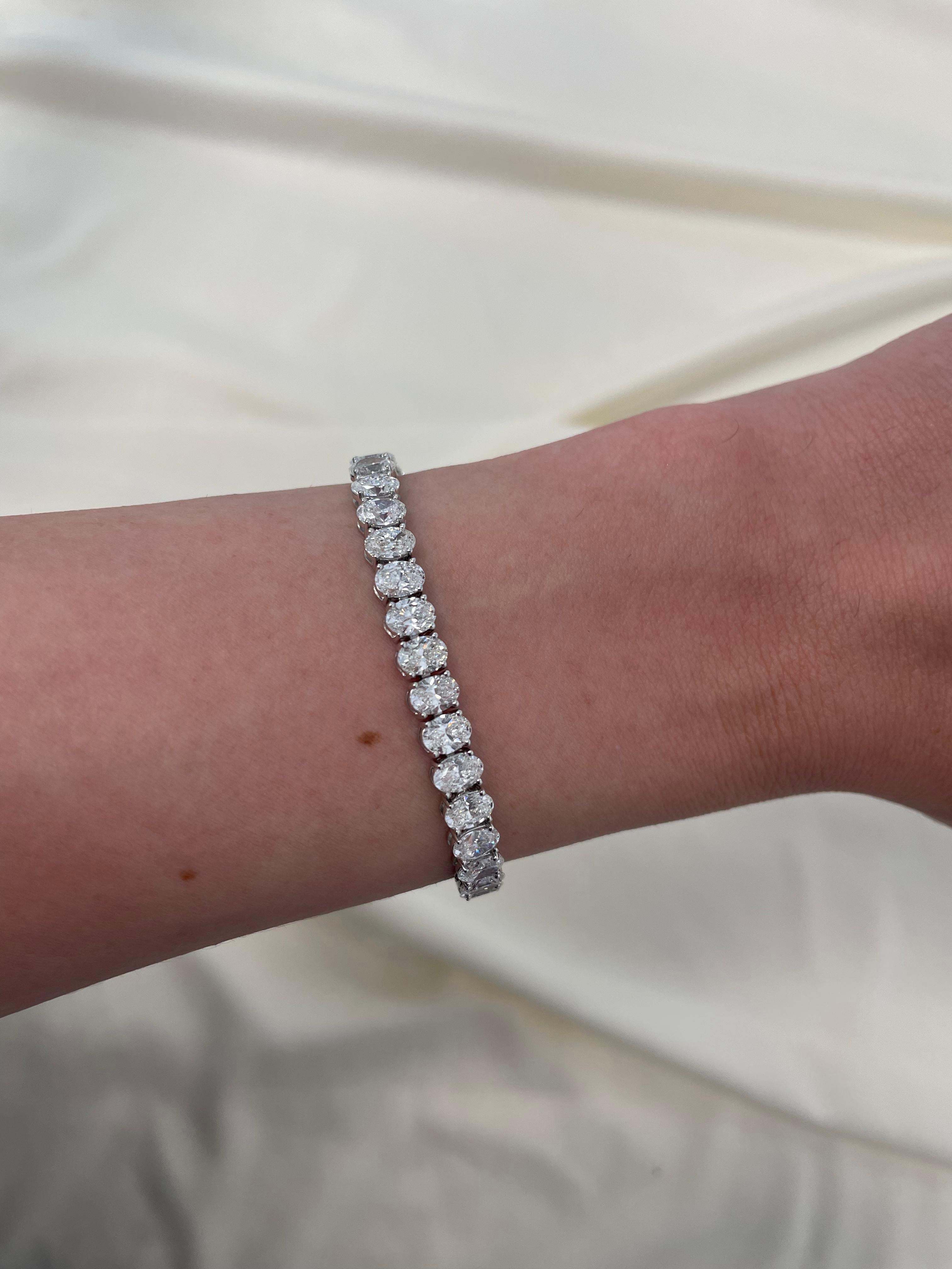 Stunning modern straight oval cut diamond tennis bracelet. High jewelry by Alexander Beverly Hills.
45 oval cut diamonds, 13.37 carats. Approximately F/G color and VS2/SI1 clarity. 18k white gold, 13.49 grams, 7 inches.
Accommodated with an up to