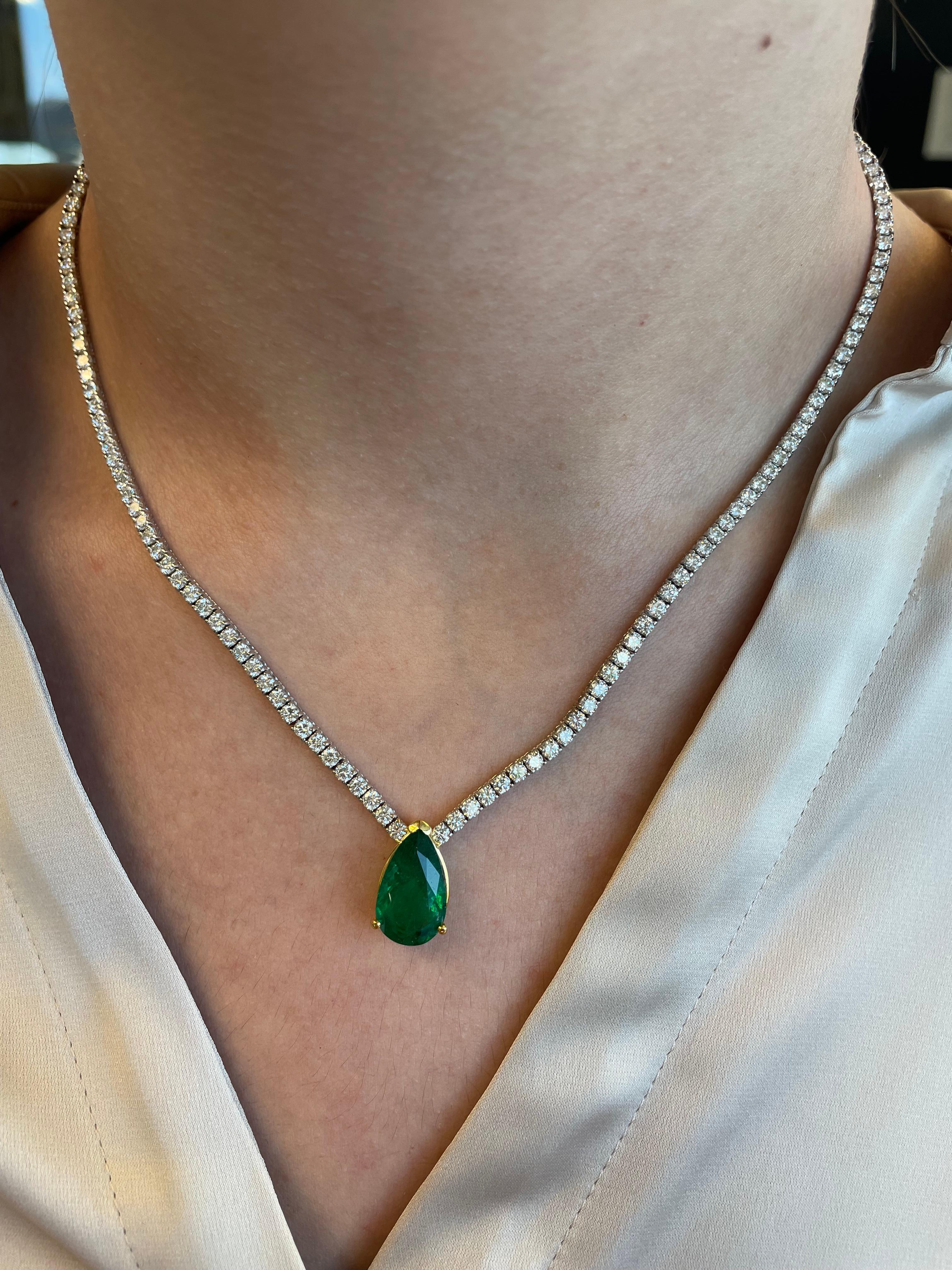 Modern diamond tennis necklace with a emerald center stone. High jewelry by Alexander Beverly Hills.
4.46 carat pear shape emerald, apx F2. 150 round brilliant diamonds, 9.00 carats. Approximately H/I color and SI clarity. 18k white & yellow gold,