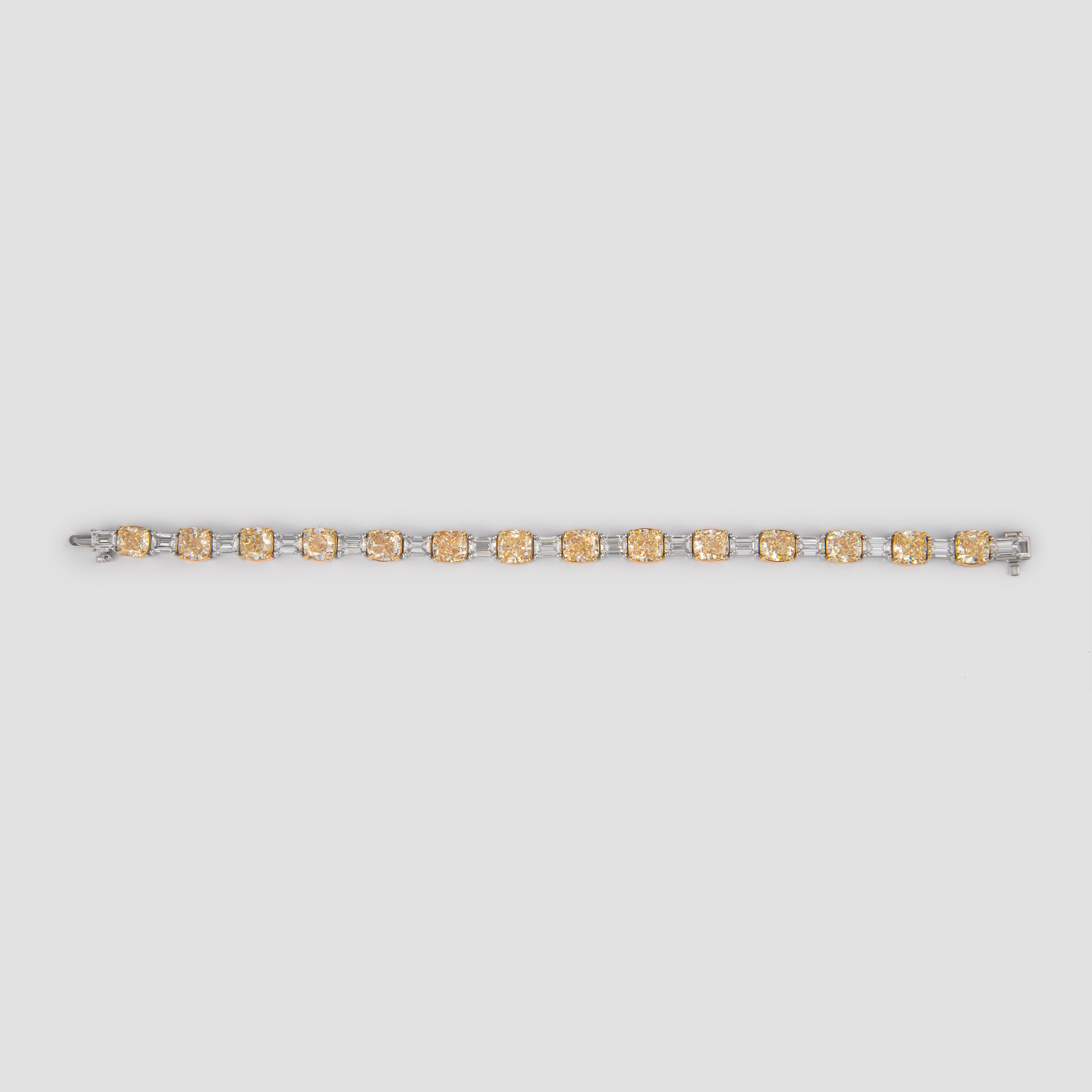 Alternating cushion & emerald cut diamond bracelet, all yellowish diamonds with GIA report. By Alexander of Beverly Hills.
14 cushion cut diamonds, 21.42 carats total. All Y/Z color, VS1-SI2 clarity and all GIA certified. 15 emerald cut diamonds,