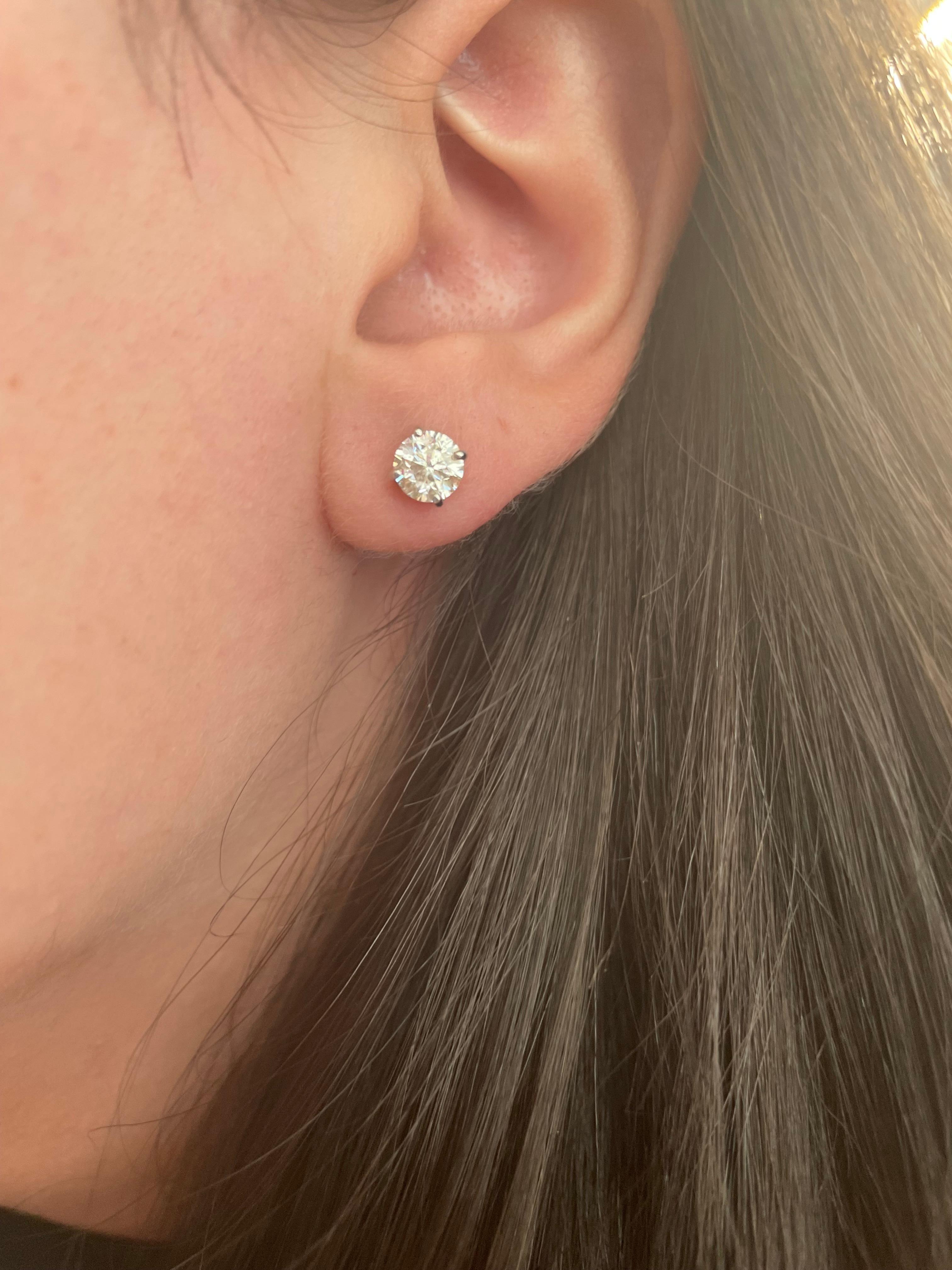Classic diamond stud earrings. By Alexander Beverly Hills.
Two round brilliant diamonds 1.46 carats total. Approximately G color and SI clarity. Four prong set, 14k white gold. 
Accommodated with an up to date appraisal by a GIA G.G. upon request.