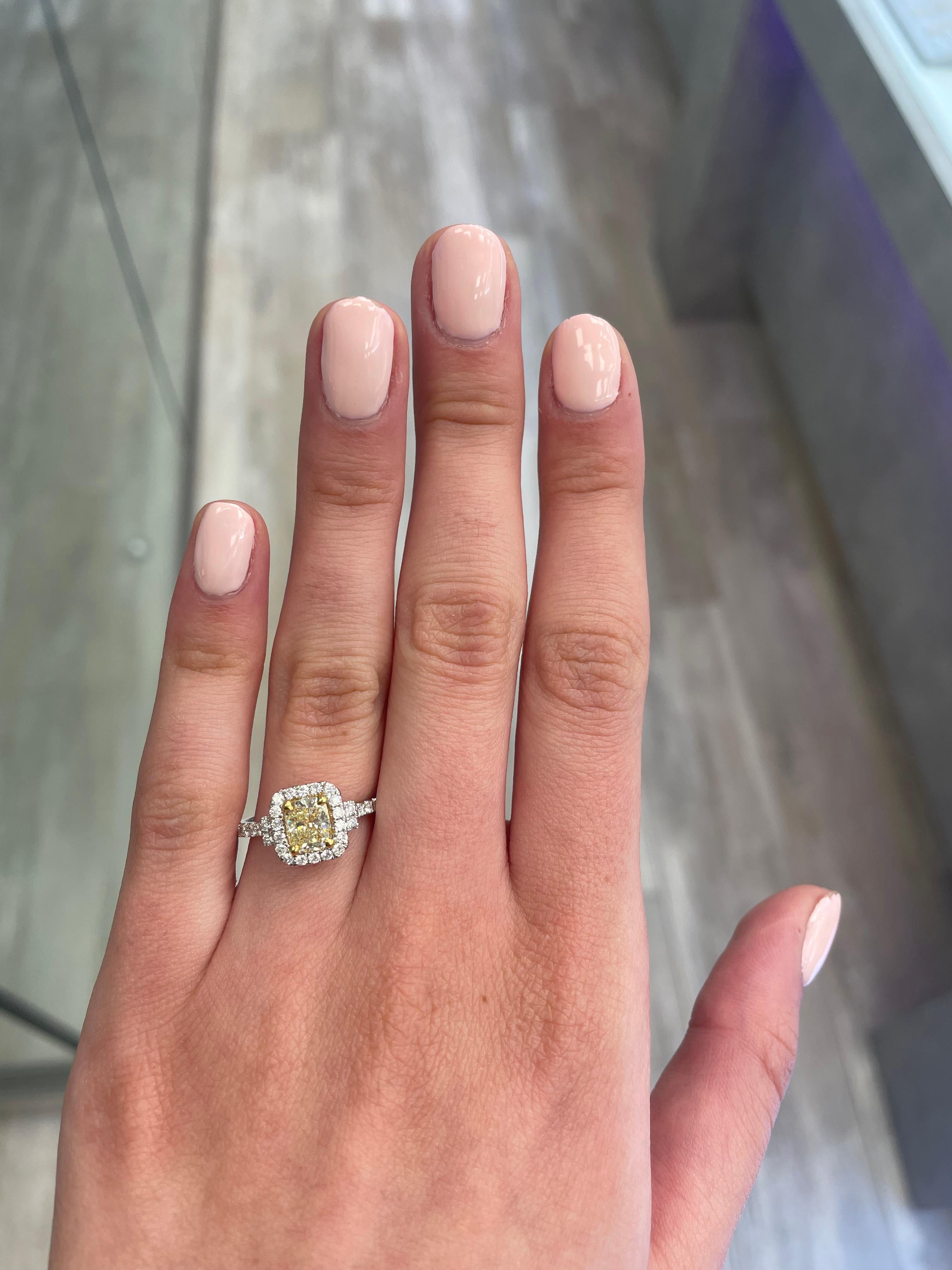 Stunning modern EGL certified yellow diamond with halo ring, two-tone 18k yellow and white gold. By Alexander Beverly Hills
1.47 carats total diamond weight.
1.07 carat cushion cut Fancy Yellow color and SI1 clarity diamond, EGL graded. Complimented