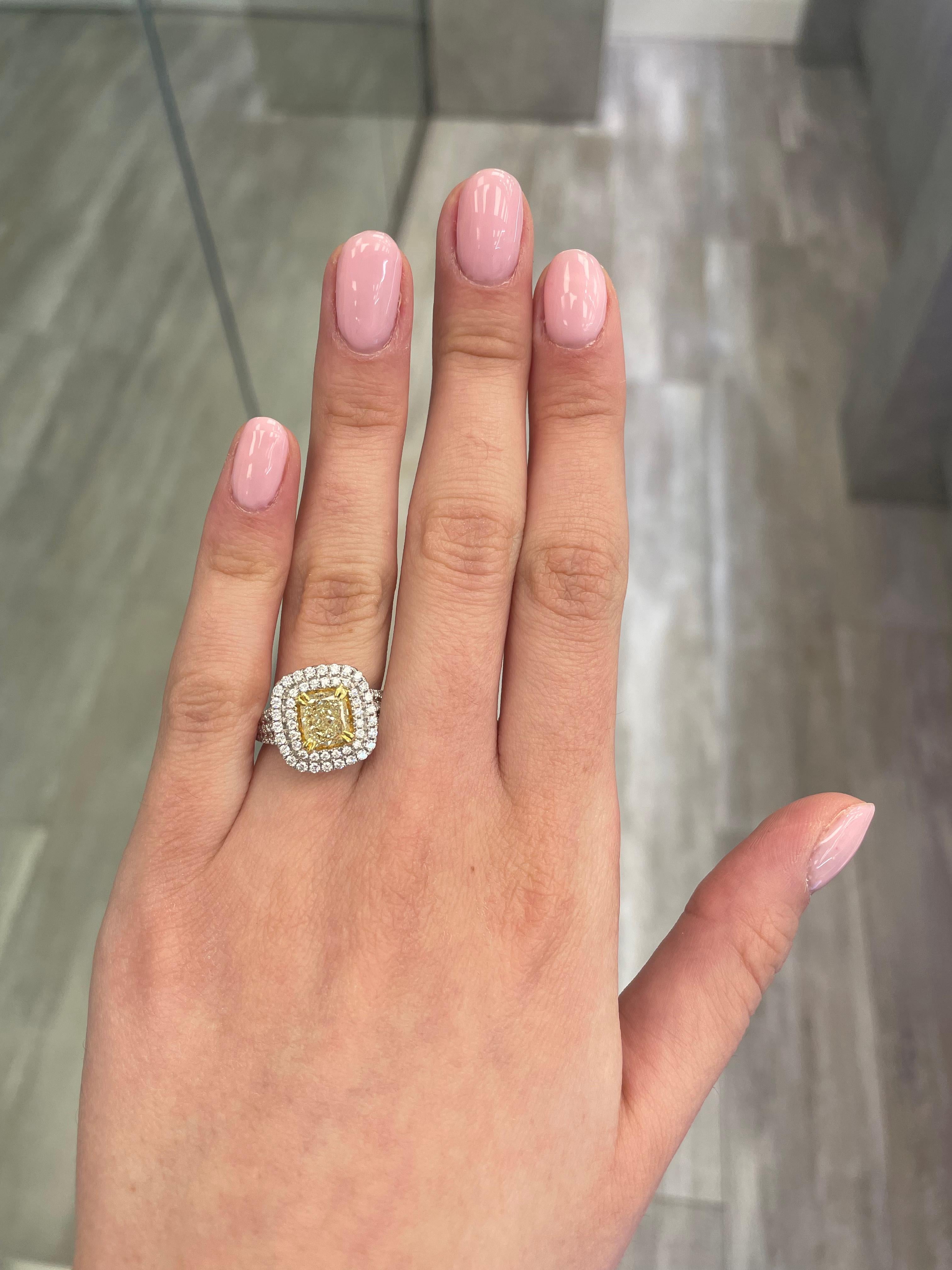 Stunning modern EGL certified fancy yellow diamond double halo ring, two-tone 18k yellow and white gold, split shank. By Alexander Beverly Hills
2.27 carats total diamond weight.
1.50 carat cushion cut Fancy Yellow color and SI1 clarity diamond, EGL
