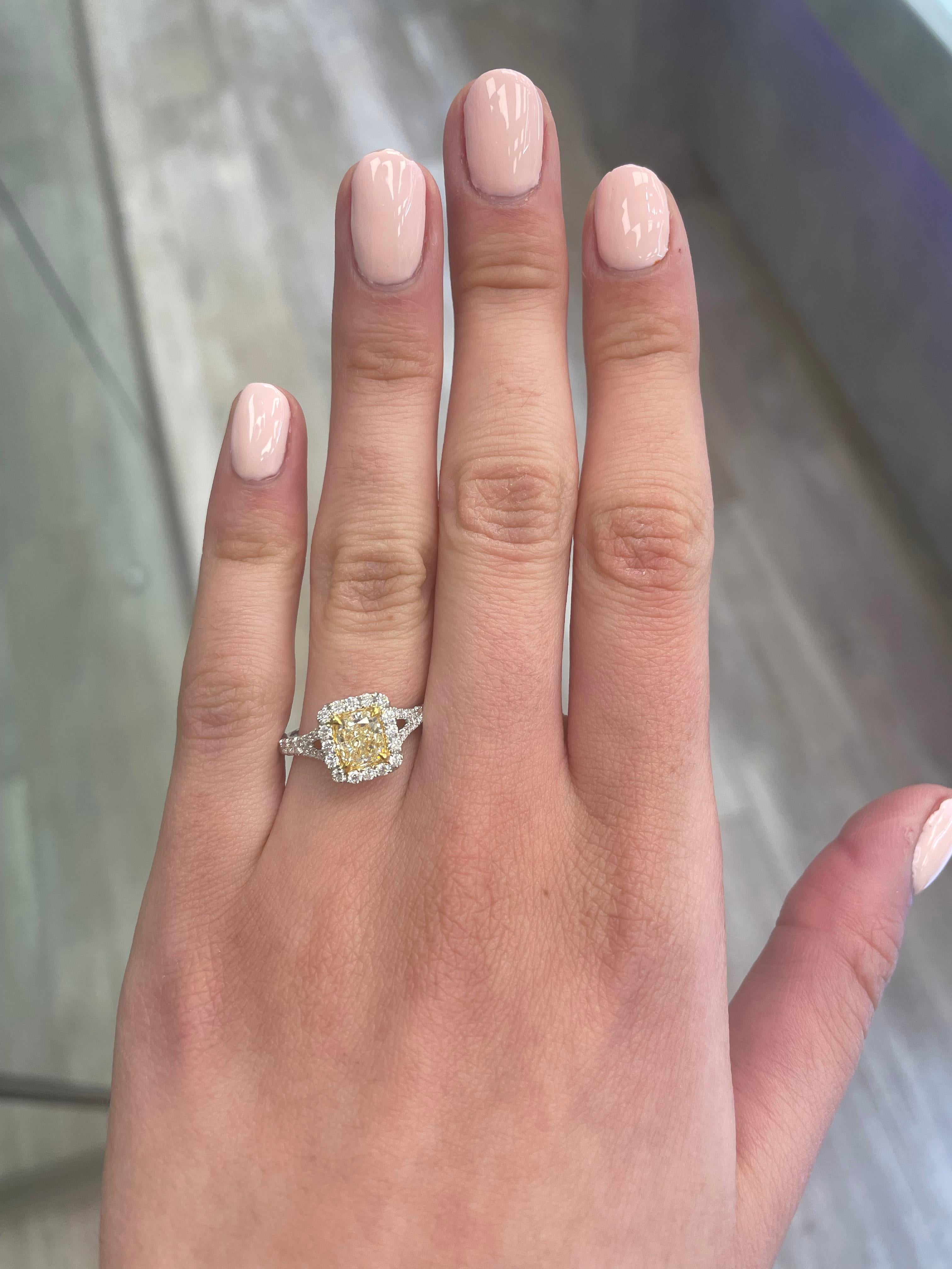 Stunning modern EGL certified yellow diamond with halo ring, two-tone 18k yellow and white gold, split shank. By Alexander Beverly Hills
1.52 carats total diamond weight.
1.02 carat cushion cut Fancy Light Yellow color and VS1 clarity diamond, EGL