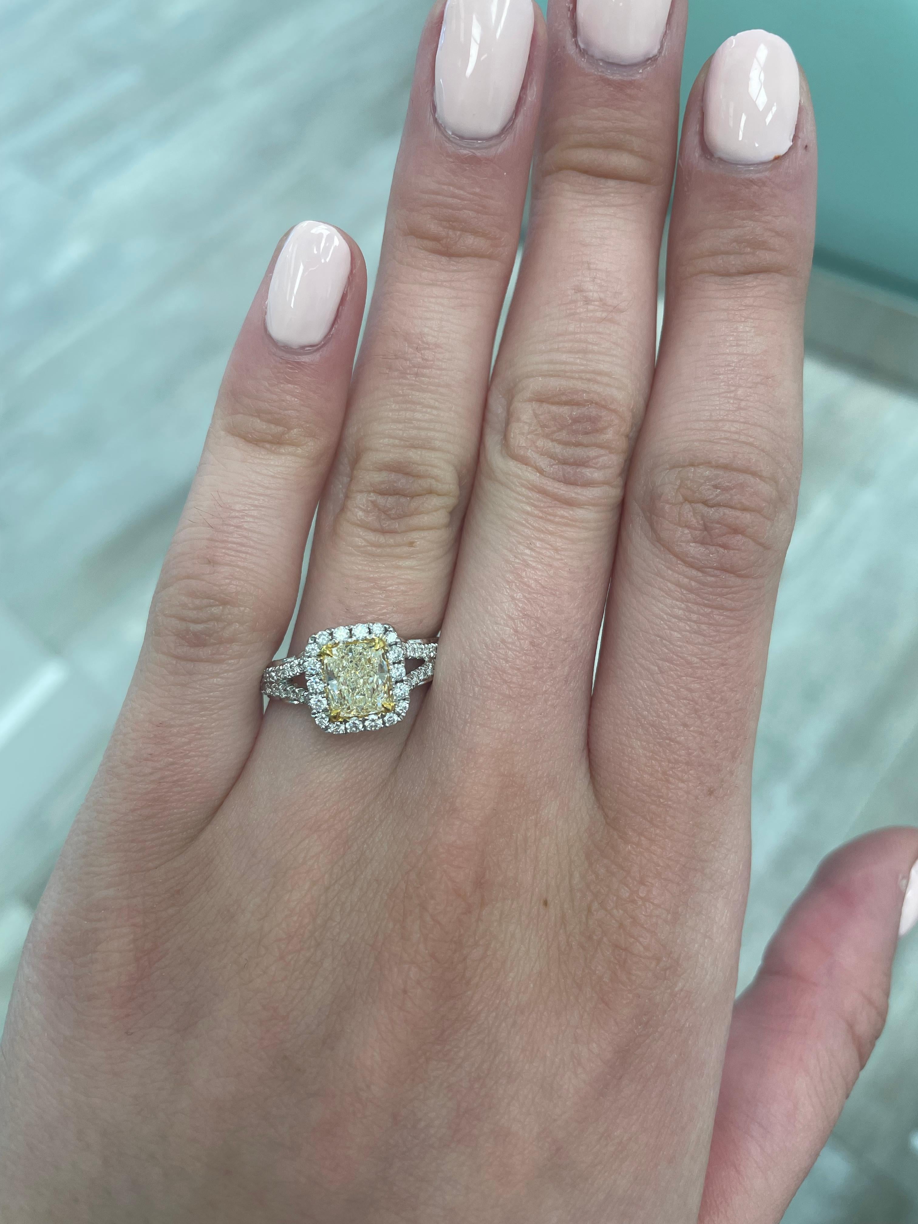 Stunning modern EGL certified yellow diamond with halo ring, two-tone 18k yellow and white gold, split shank. By Alexander Beverly Hills
1.61 carats total diamond weight.
1.15 carat cushion cut Fancy Light Yellow color and SI1 clarity diamond, EGL