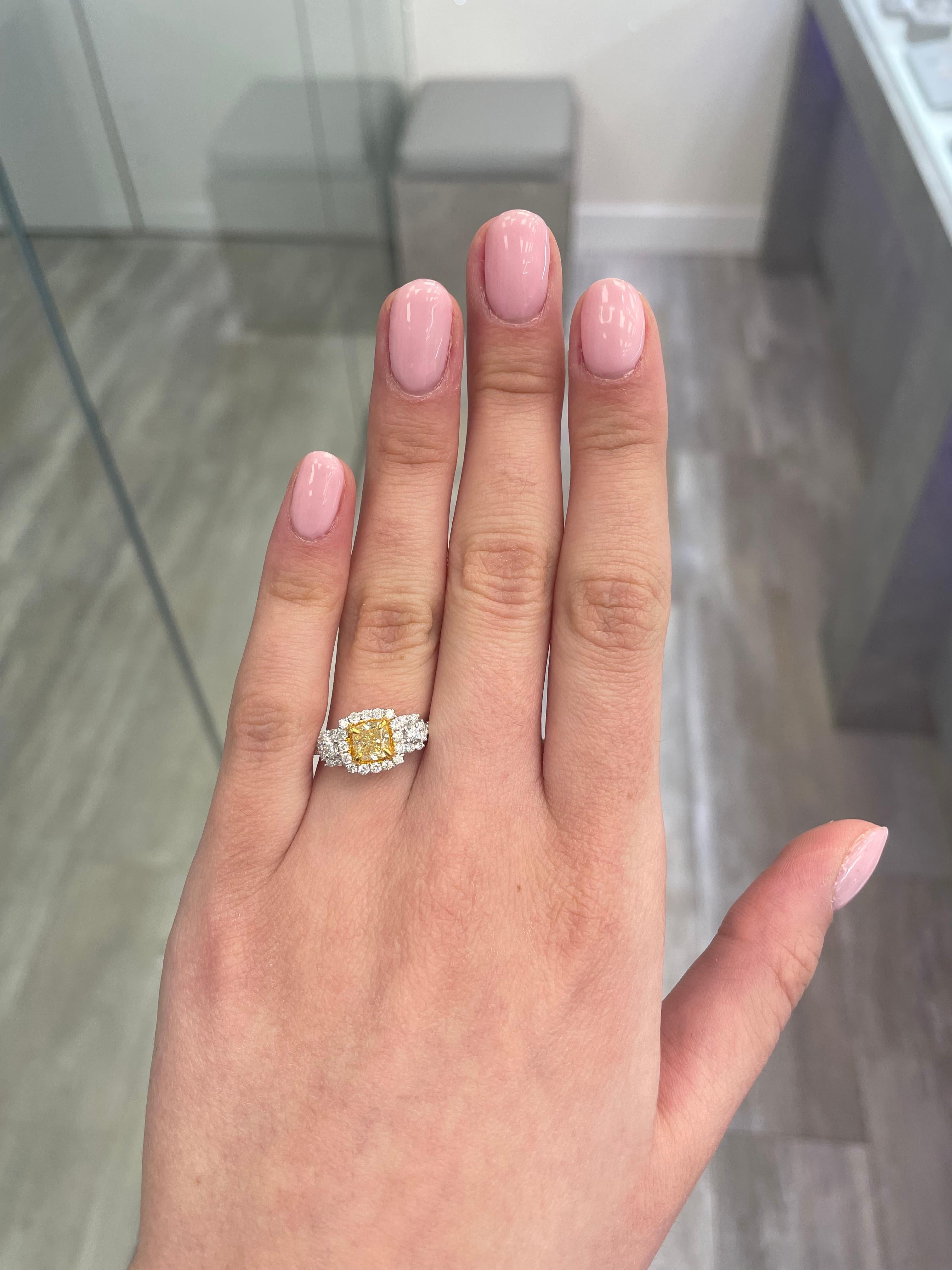 Stunning modern EGL certified fancy yellow diamond three stone halo ring, two-tone 18k yellow and white gold. By Alexander Beverly Hills
1.63 carats total diamond weight.
0.72 carat cushion Fancy Intense Yellow color and VS2 clarity diamond, EGL
