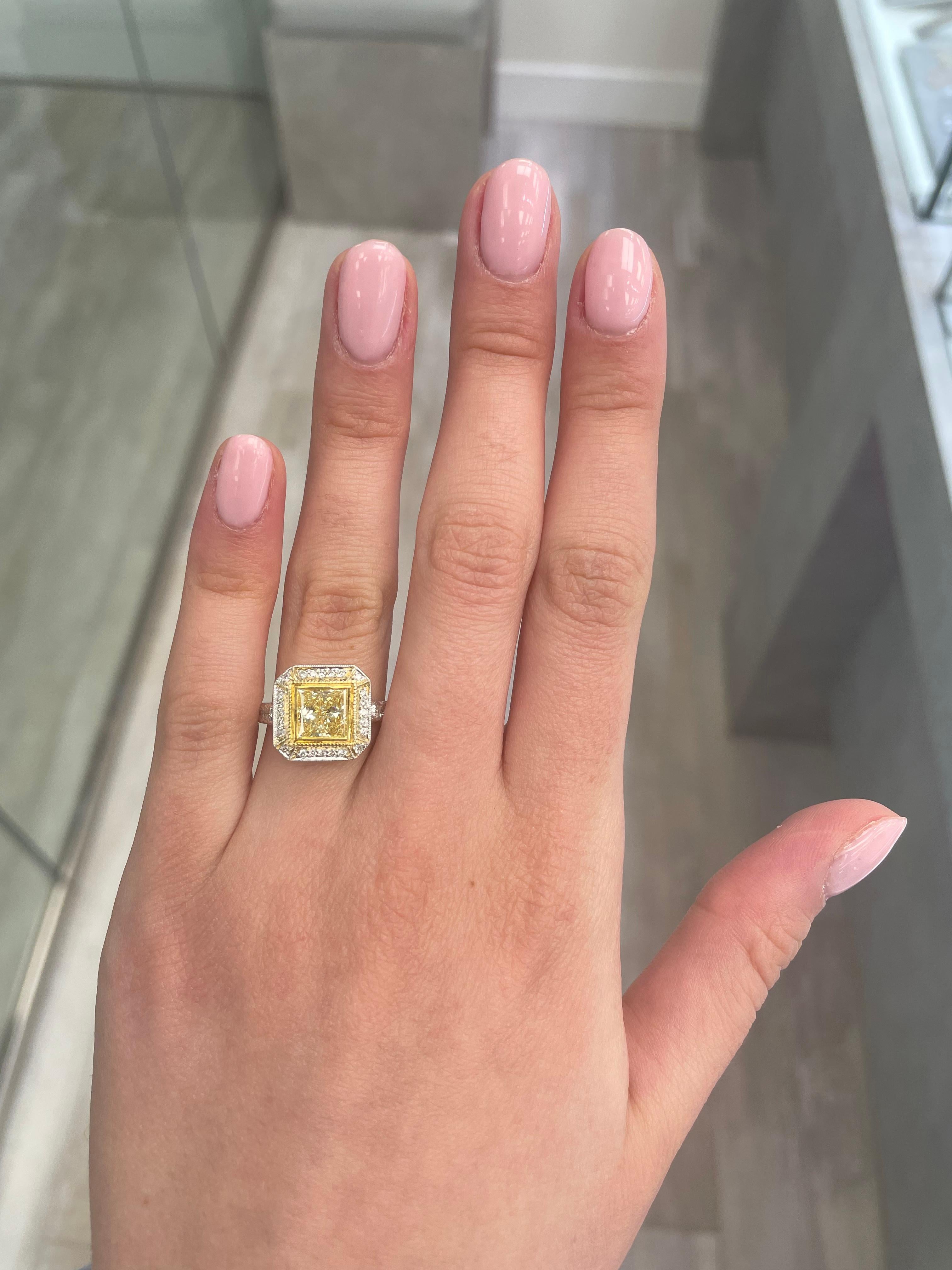Stunning modern EGL certified fancy yellow diamond halo ring, two-tone 18k yellow and white gold, with milgrain work. By Alexander Beverly Hills
2.43 carats total diamond weight.
1.64 carat princess cut Fancy Yellow color and SI3 clarity diamond,