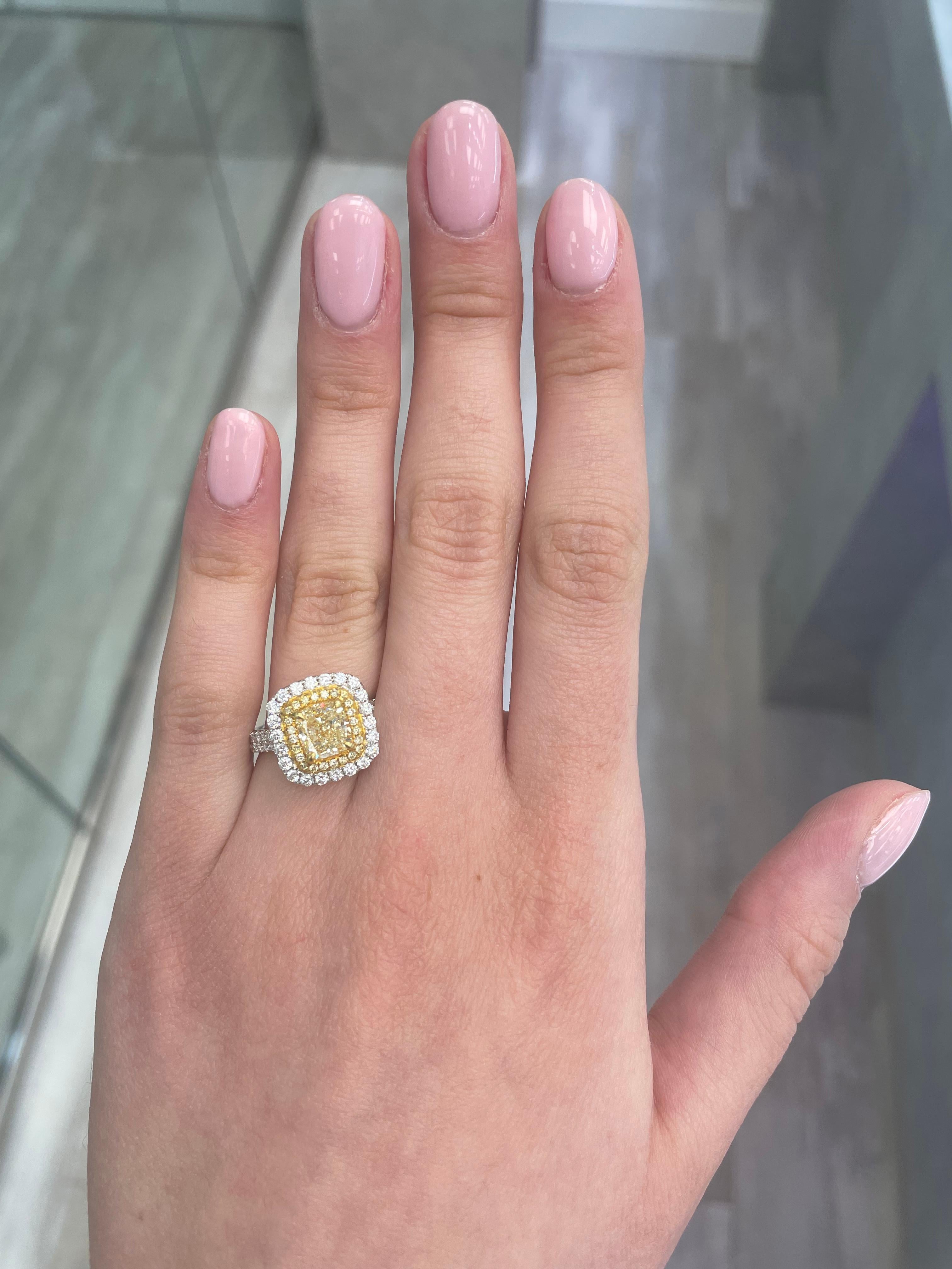 Stunning modern EGL certified yellow diamond double halo ring, two-tone 18k yellow and white gold, split shank. By Alexander Beverly Hills.
2.45 carats total diamond weight.
1.65 carat cushion cut Fancy Yellow color and VS2 clarity diamond, EGL