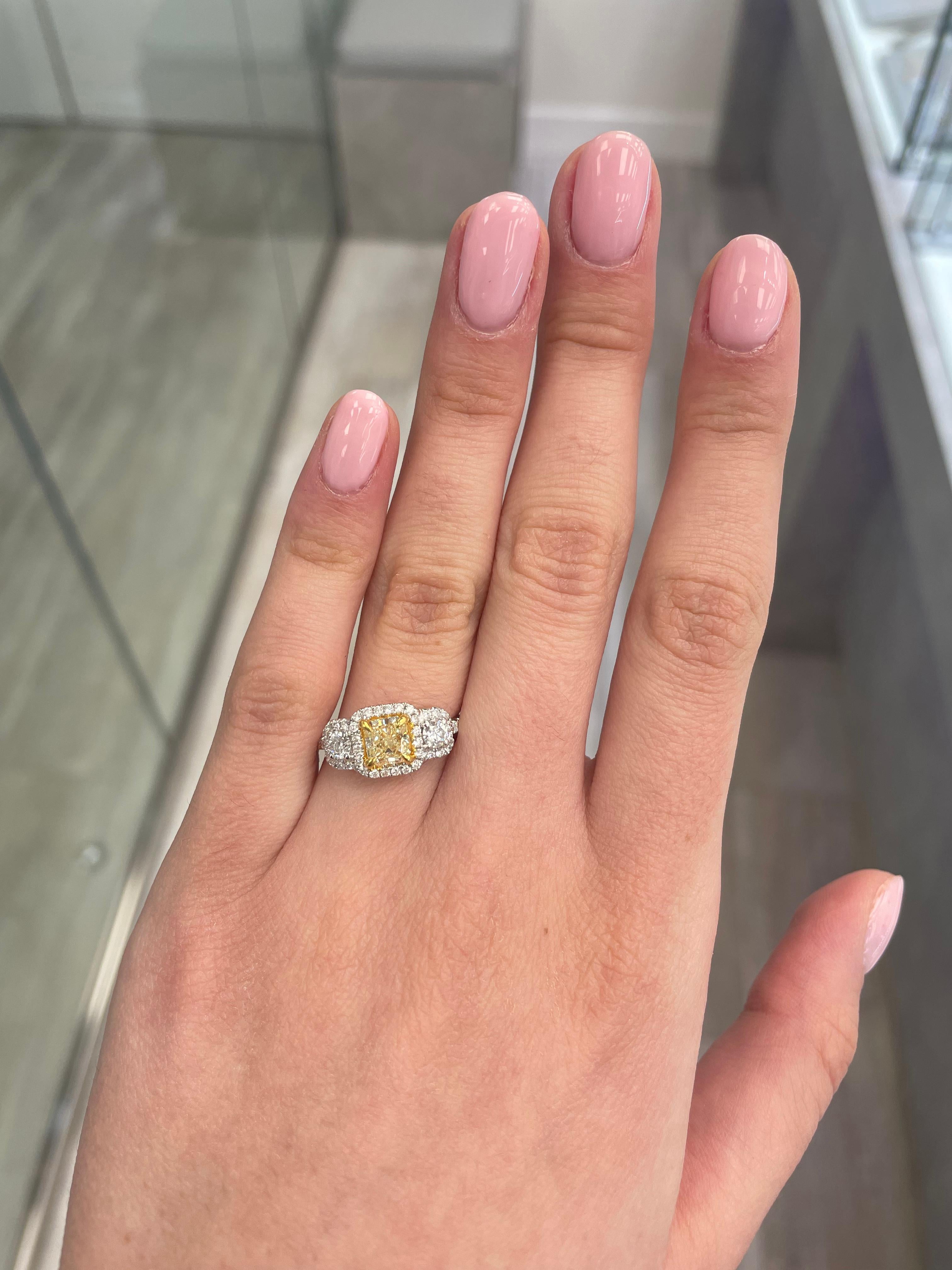 Stunning modern EGL certified fancy yellow diamond three stone halo ring, two-tone 18k yellow and white gold. By Alexander Beverly Hills
1.65 carats total diamond weight.
1.01 carat cushion Fancy Yellow color and VS1 clarity diamond, EGL graded.