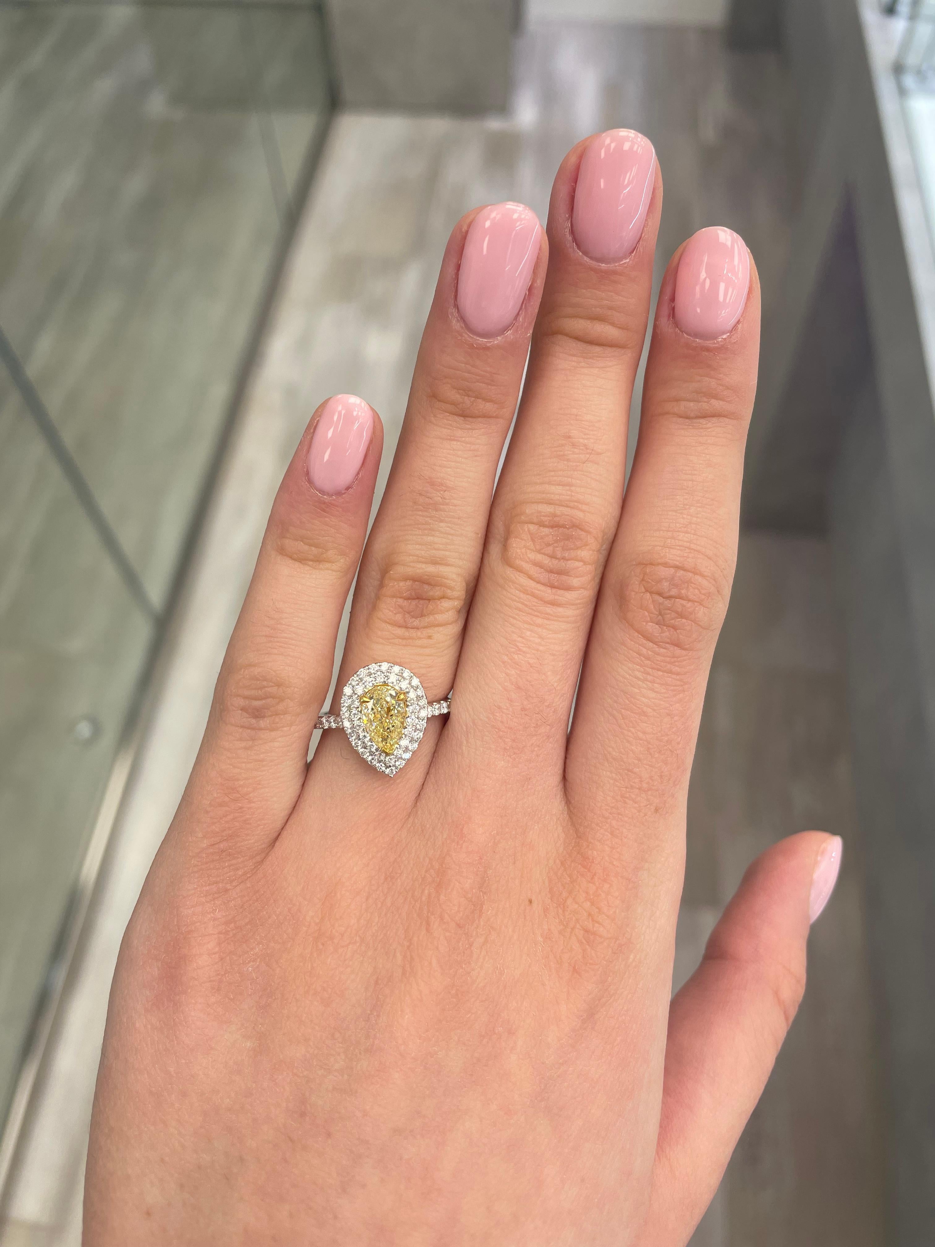 Stunning modern EGL certified yellow diamond double halo ring, two-tone 18k yellow and white gold. By Alexander Beverly Hills
1.68 carats total diamond weight.
1.06 carat pear cut Fancy Yellow color and SI2 clarity diamond, EGL graded in the