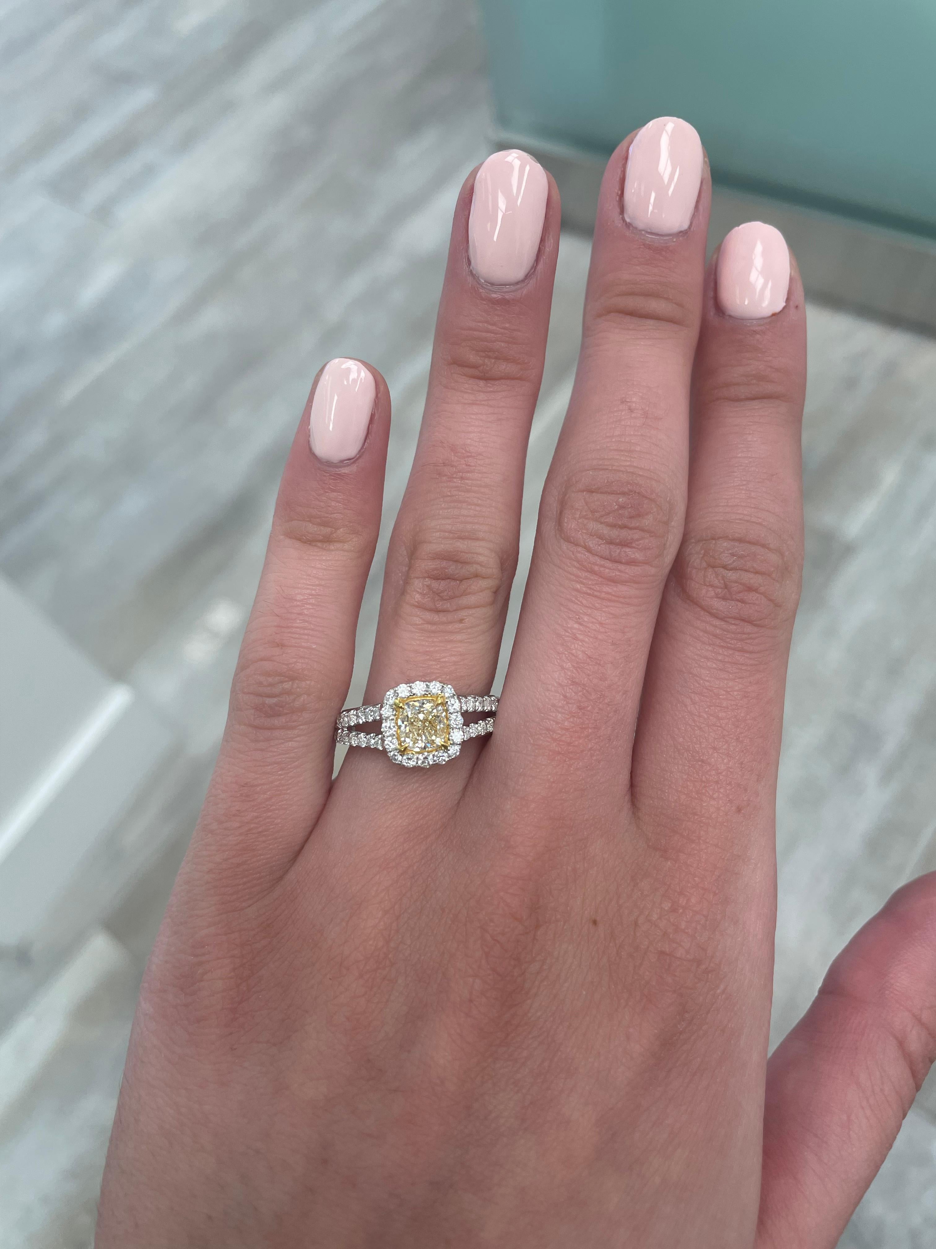 Stunning modern EGL certified yellow diamond with halo ring, two-tone 18k yellow and white gold, split shank. By Alexander Beverly Hills
1.70 carats total diamond weight.
1.01 carat cushion cut Fancy Light Yellow color and VS2 clarity diamond, EGL