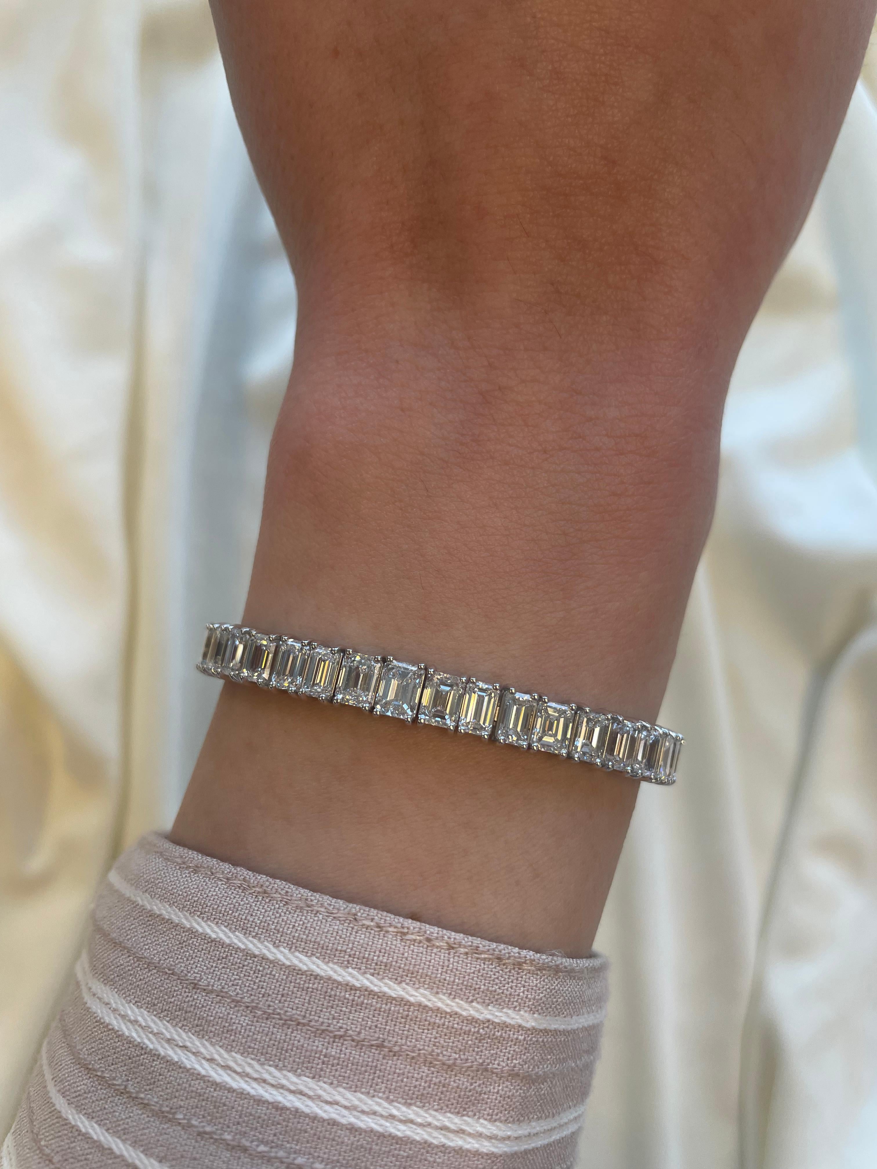 Stunning modern straight emerald cut diamond tennis bracelet. High jewelry by Alexander Beverly Hills.
50 emerald cut diamonds, 17.15 carats (apx 0.34ct each). Approximately H/I color and VS clarity. 18k white gold, 19.85 grams.
Accommodated with an