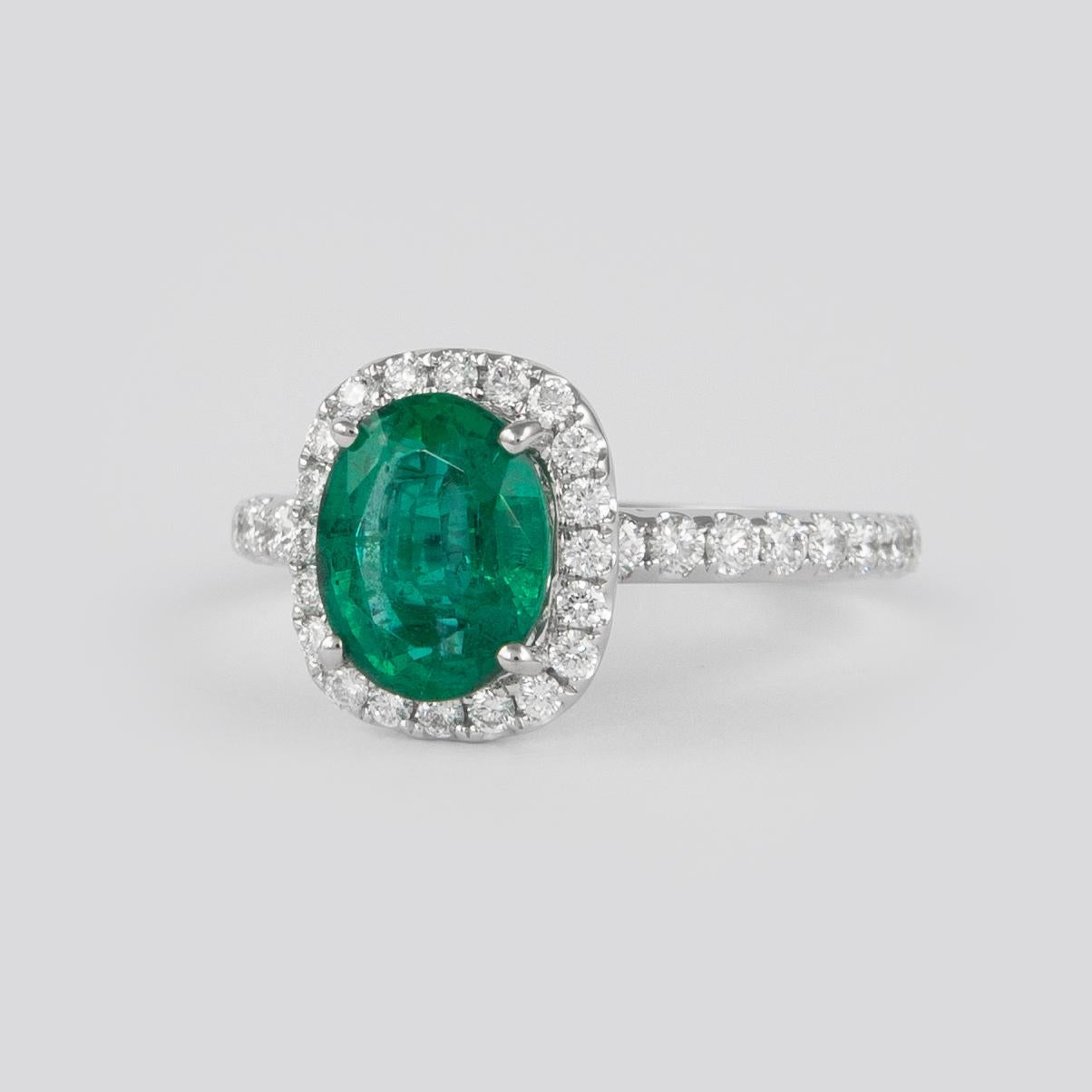 Lovely emerald with diamond halo ring. By Alexander of Beverly Hills.
1.72 carat oval emerald complimented with 54 round brilliant diamonds, 0.75ct. Approximately G/H color and VS2/SI1 clarity. 2.47ct total gemstone weight, in 18k white gold.