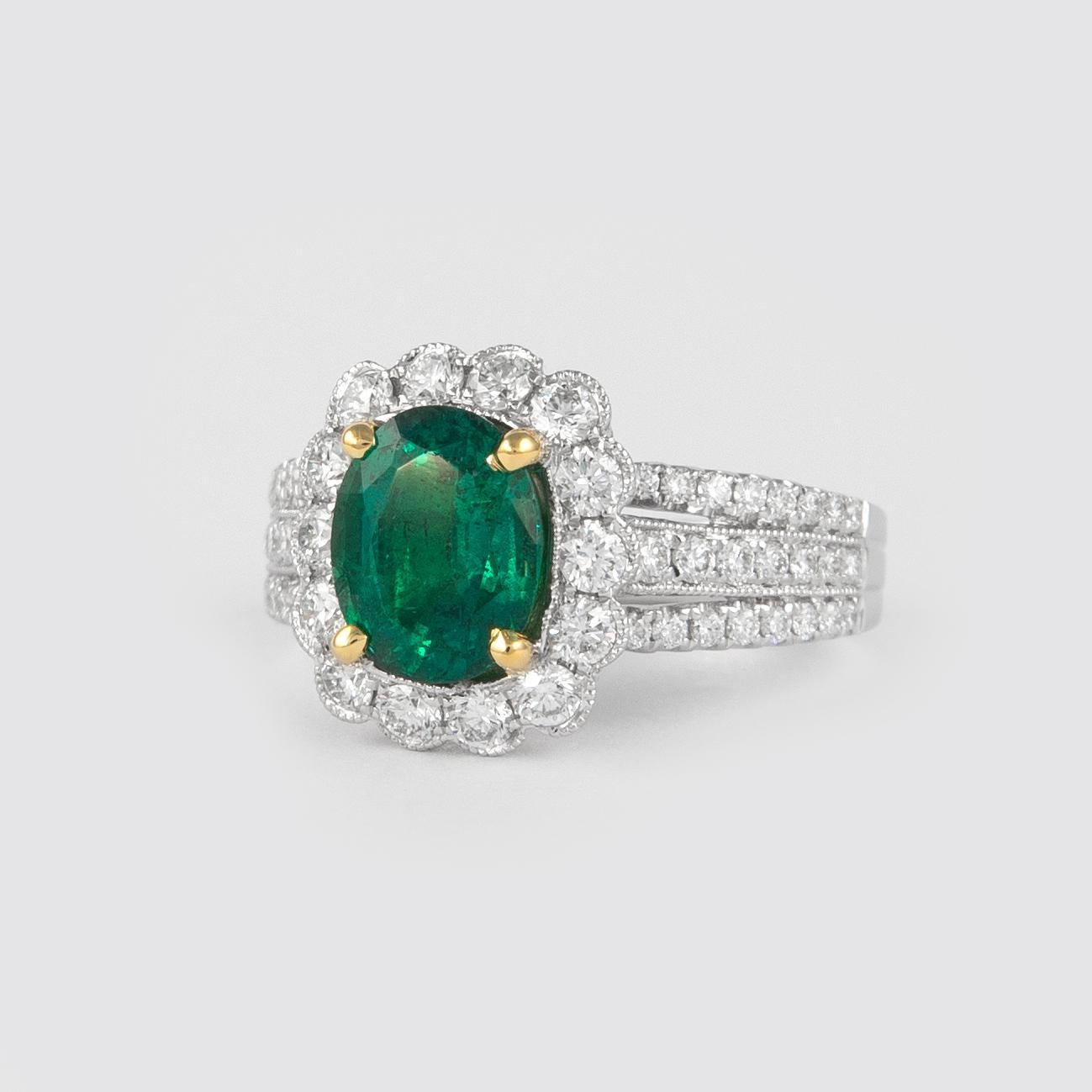 Lovely emerald with diamond halo ring. By Alexander of Beverly Hills.
1.72 carat oval emerald complimented with 60 round brilliant diamonds, 1.72ct. Approximately G/H color and SI clarity. 2.67ct total gemstone weight, in 18k white gold and yellow