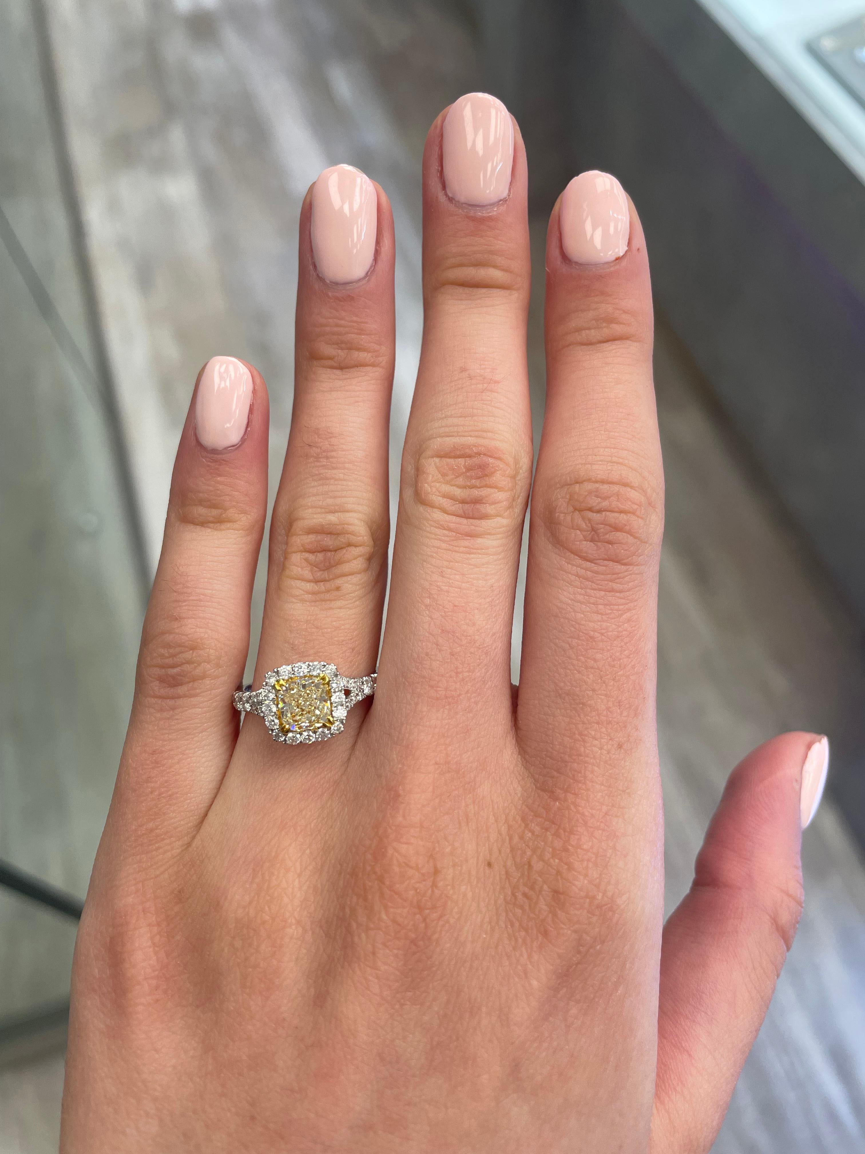 Stunning modern EGL certified yellow diamond with halo ring, two-tone 18k yellow and white gold, split shank. By Alexander Beverly Hills
1.72 carats total diamond weight.
1.14 carat cushion cut Fancy Light Yellow color and VS1 clarity diamond, EGL