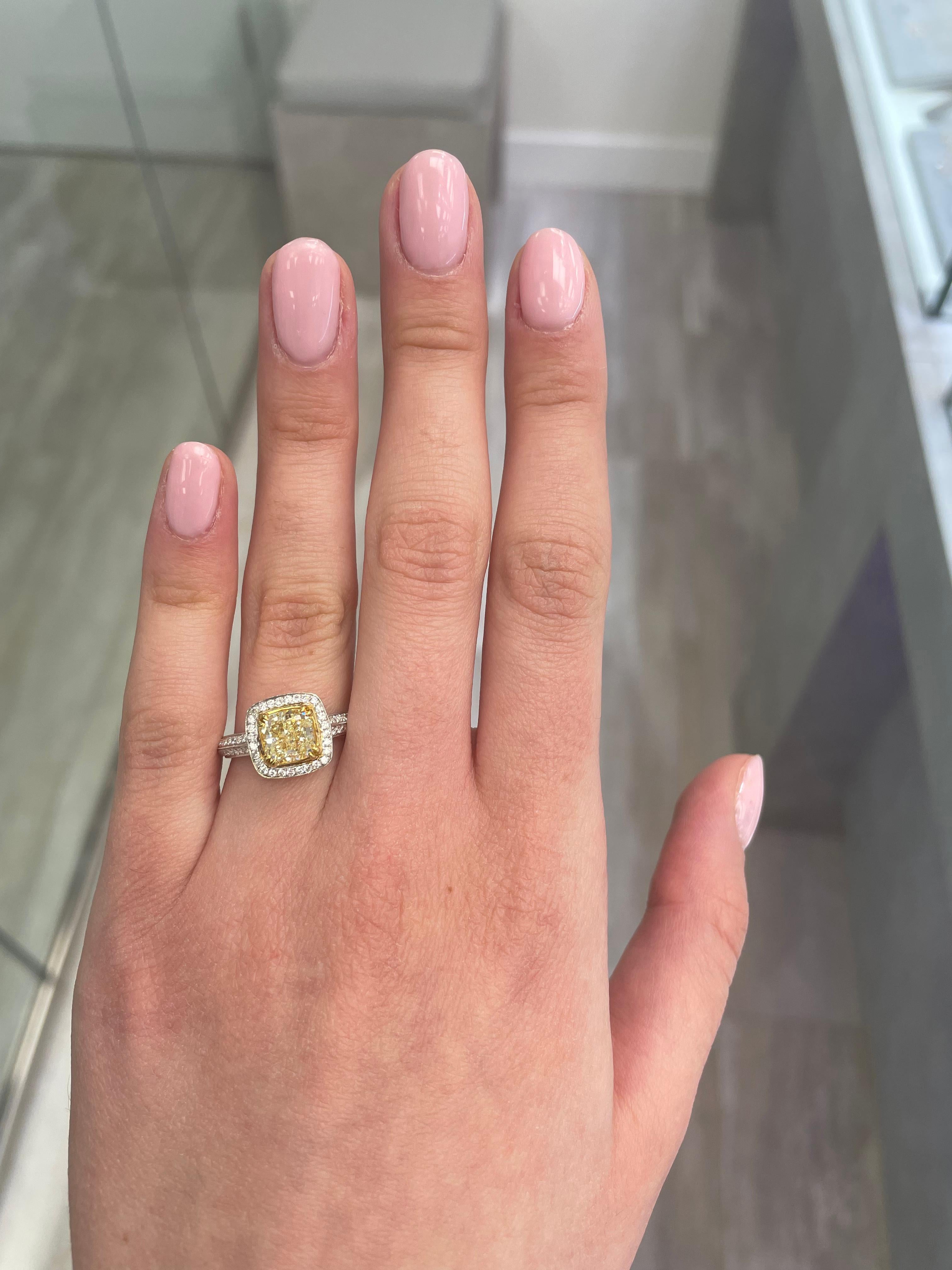 Stunning modern EGL certified fancy intense yellow diamond halo ring, two-tone 18k yellow and white gold. By Alexander Beverly Hills
2.07 carats total diamond weight.
1.73 carat cushion Fancy Intense Yellow color and VS1 clarity diamond, EGL graded.