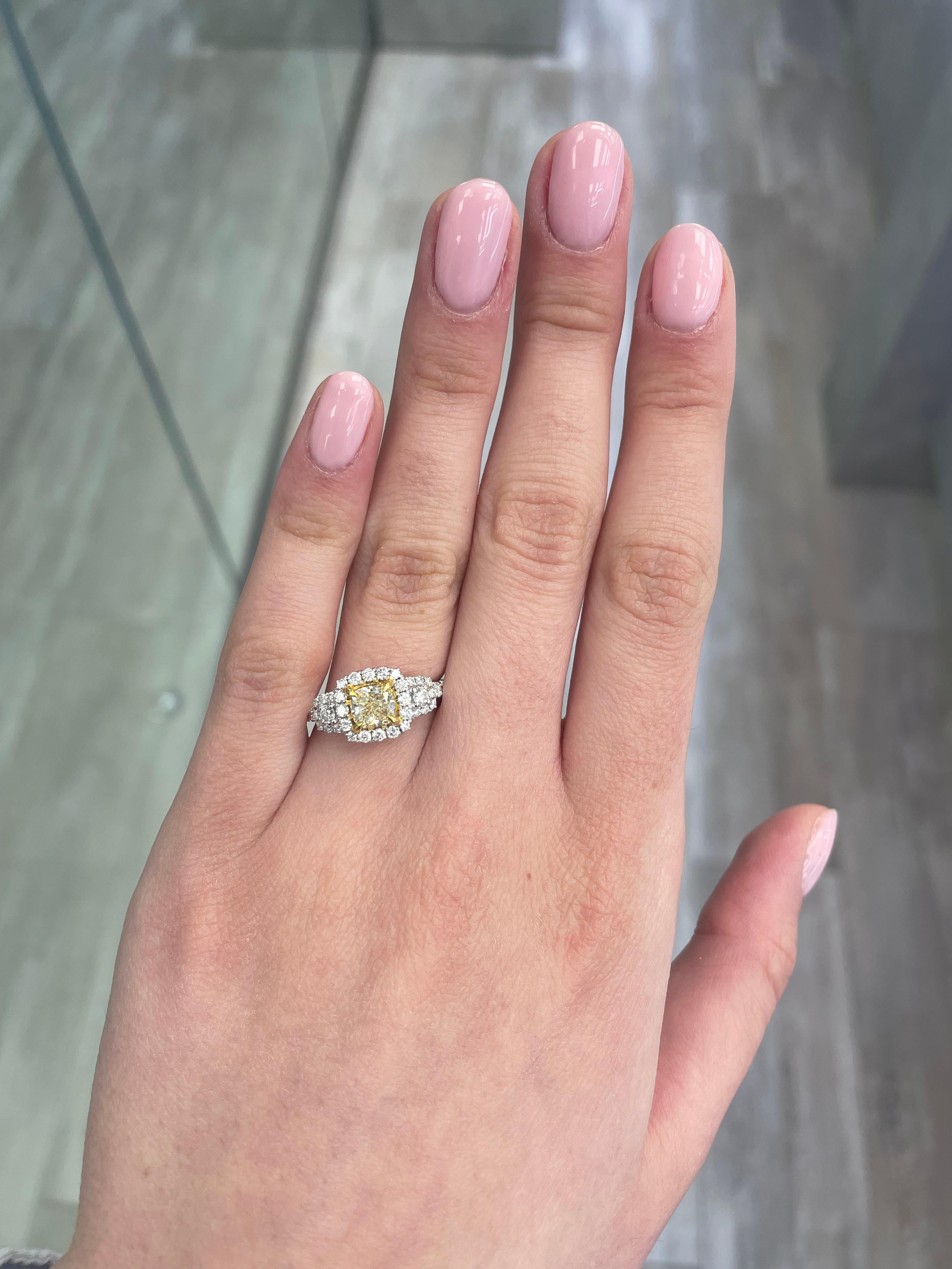 Stunning modern EGL certified fancy yellow diamond three stone halo ring, two-tone 18k yellow and white gold. By Alexander Beverly Hills
1.74 carats total diamond weight.
1.01 carat cushion Fancy Yellow color and VS1 clarity diamond, EGL graded.