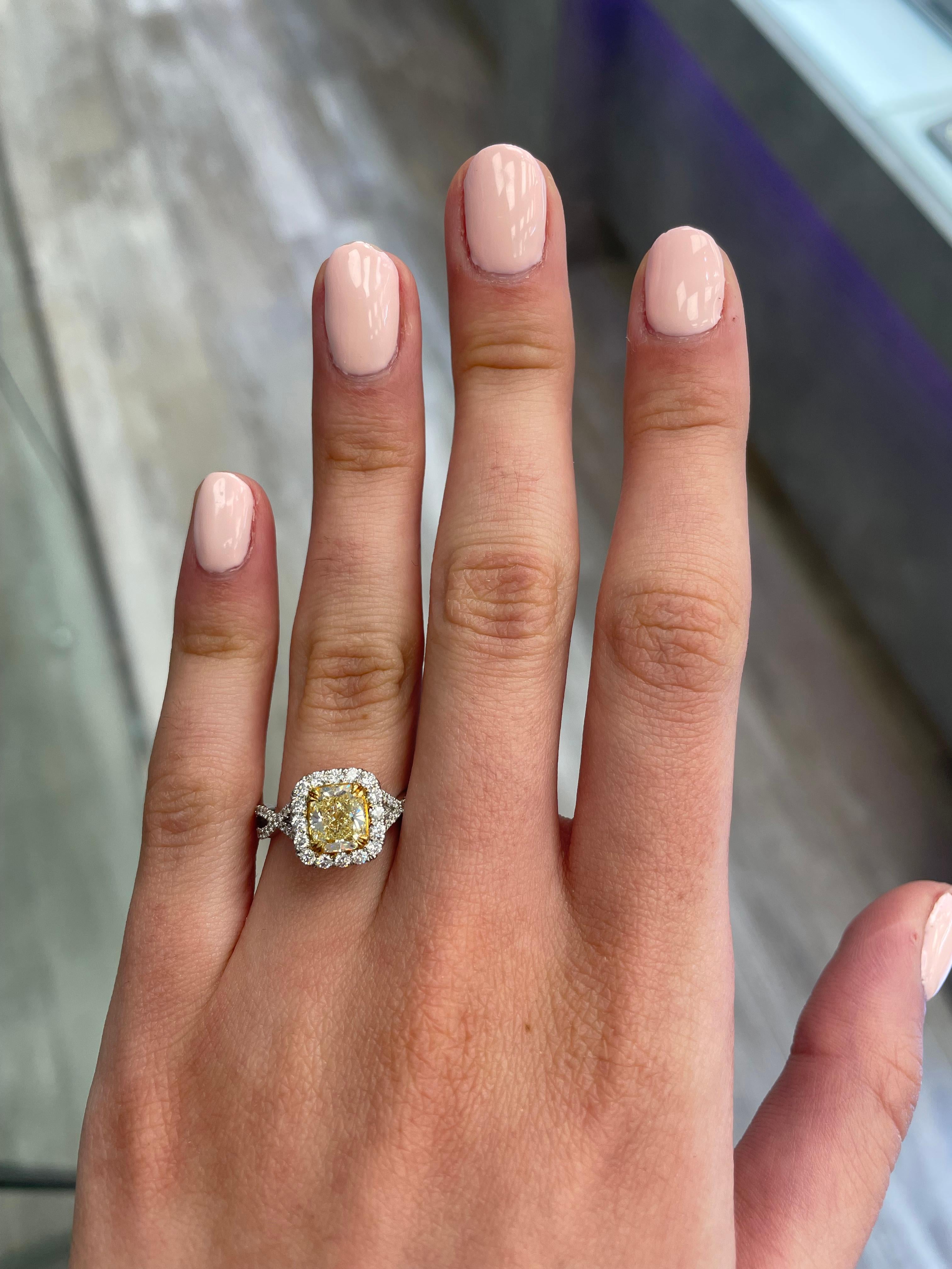 Stunning modern EGL certified yellow diamond with halo ring, two-tone 18k yellow and white gold, twist shank. By Alexander Beverly Hills
1.75 carats total diamond weight.
1.20 carat cushion cut Fancy Light Yellow color and VS2 clarity diamond, EGL