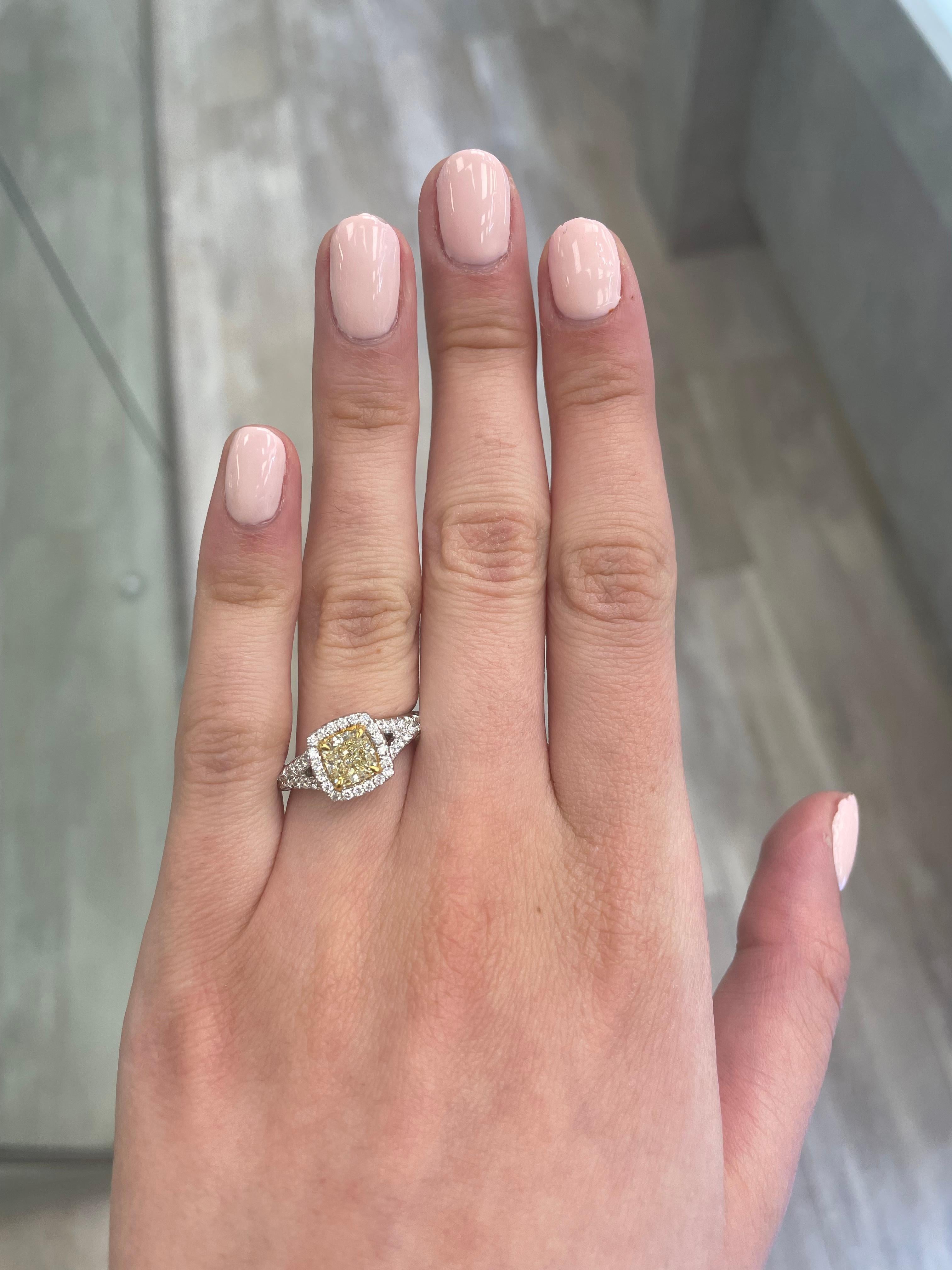 Stunning modern EGL certified yellow diamond with halo ring, two-tone 18k yellow and white gold, split shank. By Alexander Beverly Hills
1.76 carats total diamond weight.
1.23 carat cushion cut Fancy Yellow color and VVS2 clarity diamond, EGL