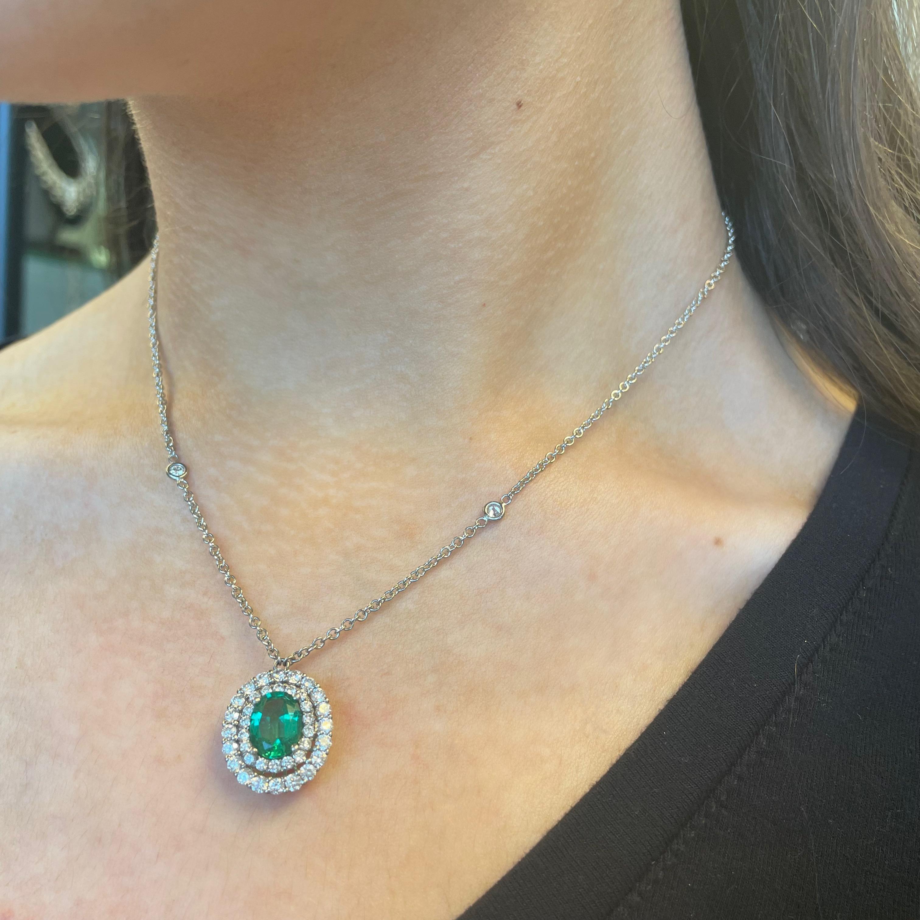 Stunning emerald pendant of superb color, with double diamond halo and diamond by the yard chain. Simple yet modern. Created by Alexander Beverly Hills.
3.27 carats total gemstone weight.
1.78 carat oval emerald, apx F2. 40 round brilliant diamonds,