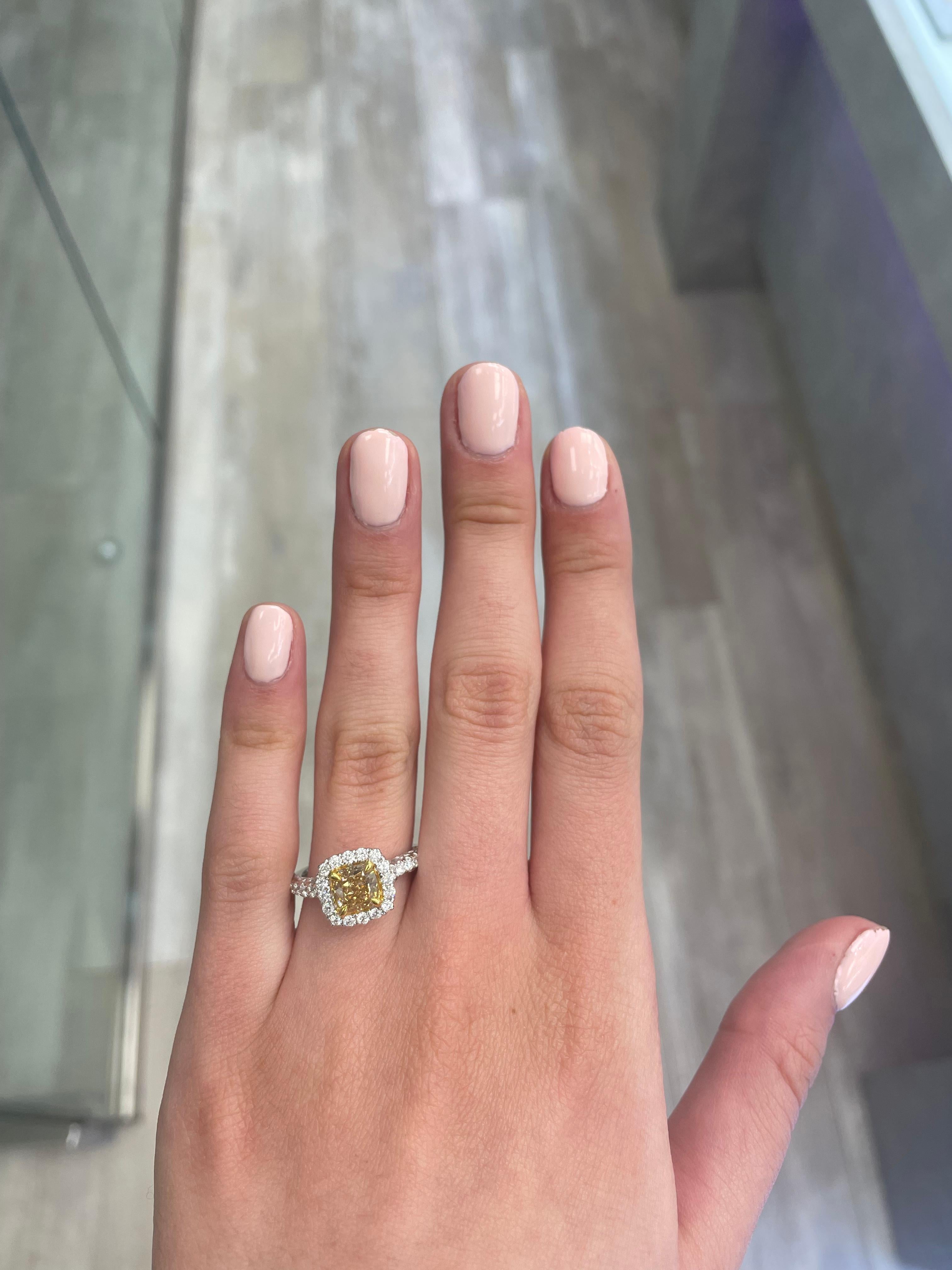 Stunning modern EGL certified yellow diamond with halo ring, two-tone 18k yellow and white gold, split shank. By Alexander Beverly Hills
1.78 carats total diamond weight.
1.15 carat cushion cut Fancy Yellowish Brown color and VVS2 clarity diamond,