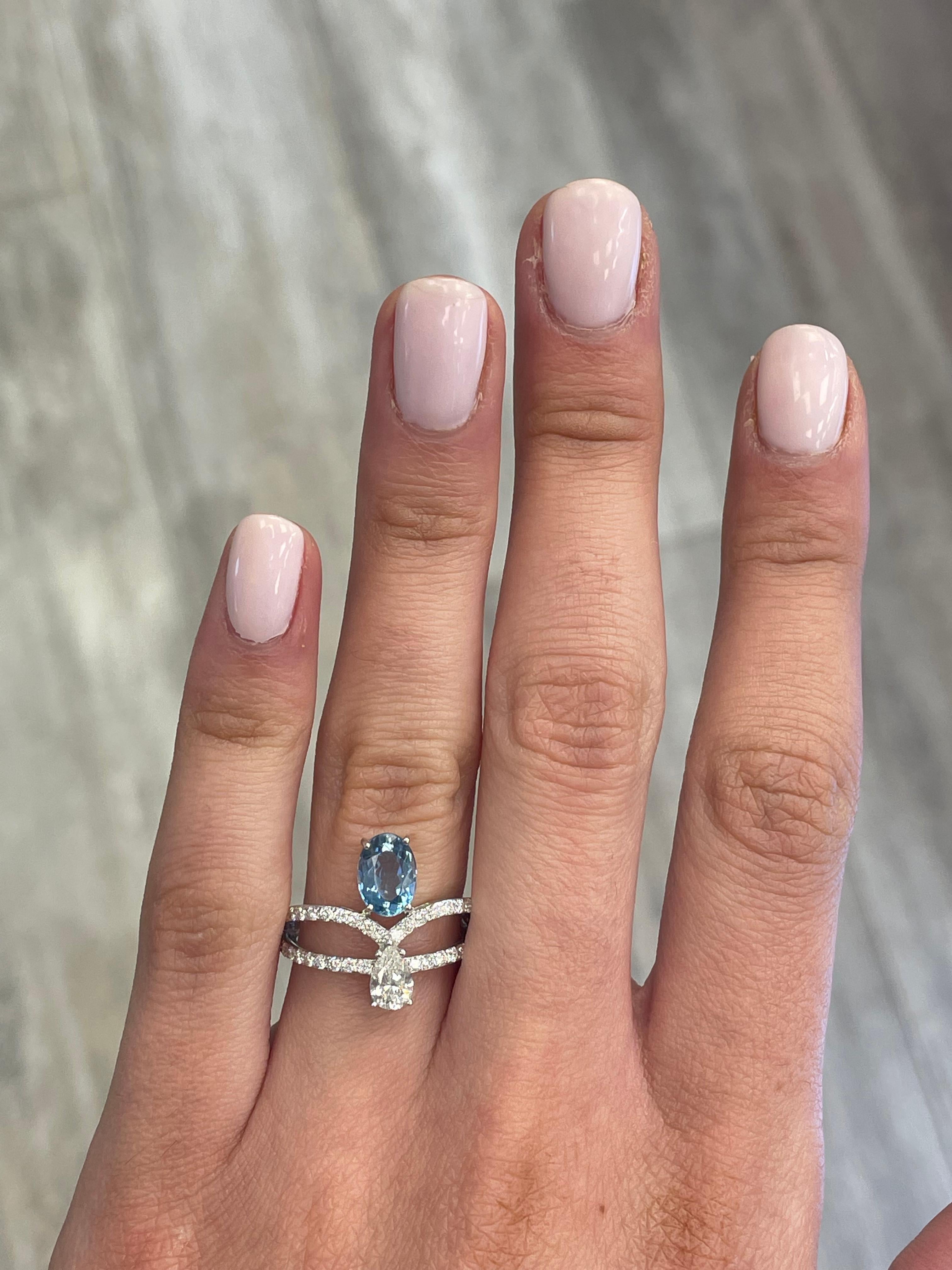 Stunning aquamarine and diamond ring, by Alexander Beverly Hills.
1 oval aquamarine, 1.02 carats. 1 pear shape diamonds, 0.38 carats, approximately F/G color and VVS clarity. Complimented by 40 round brilliant diamonds, 0.41 carats. Approximately