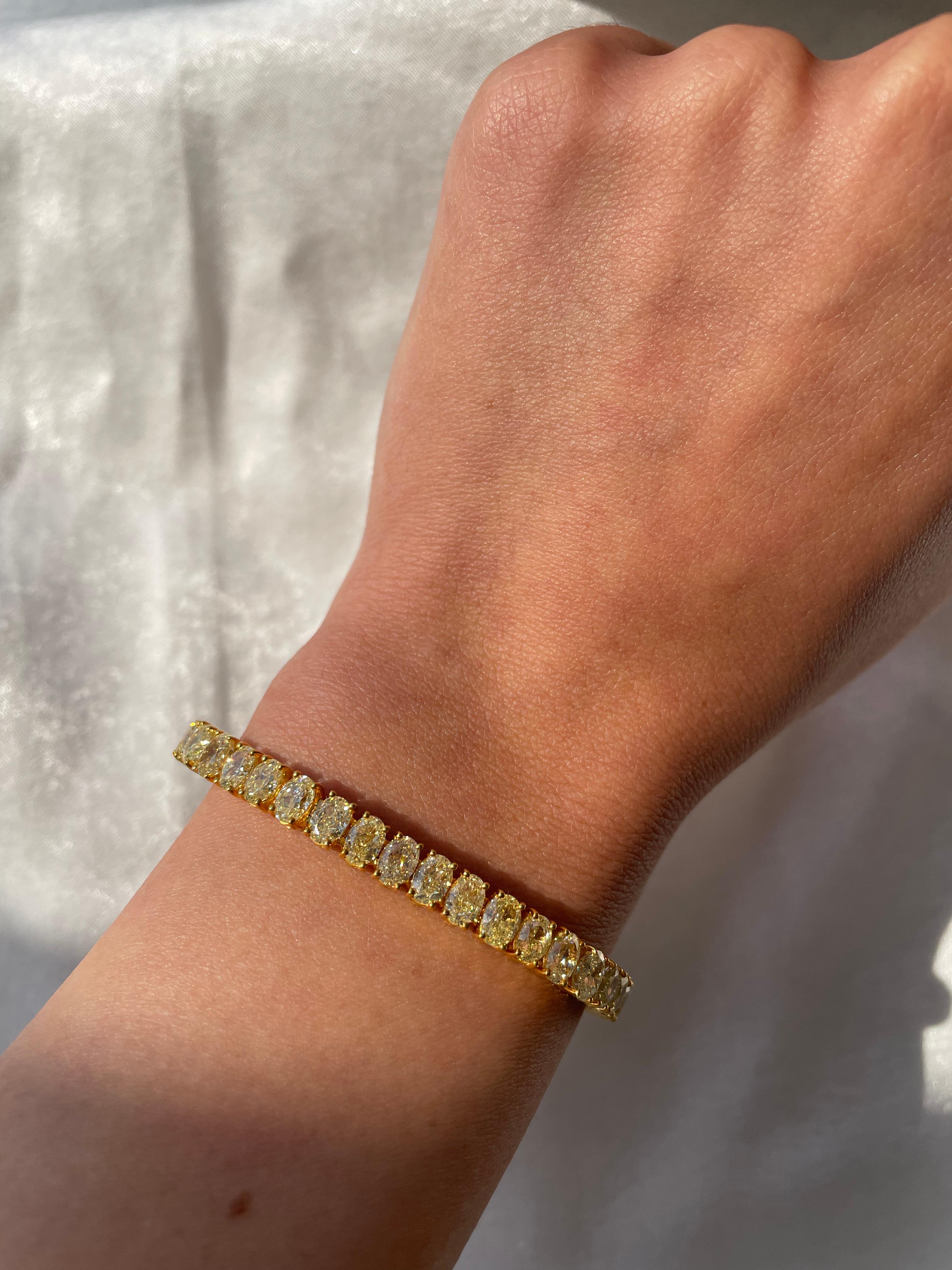 Stunning fancy yellow oval diamond tennis bracelet, difficult to find and match the stones. High jewelry by Alexander Beverly Hills.
47 oval diamonds, 18.25 carats total. Approximately Fancy Yellow color and SI clarity. Four prong set in 18k yellow