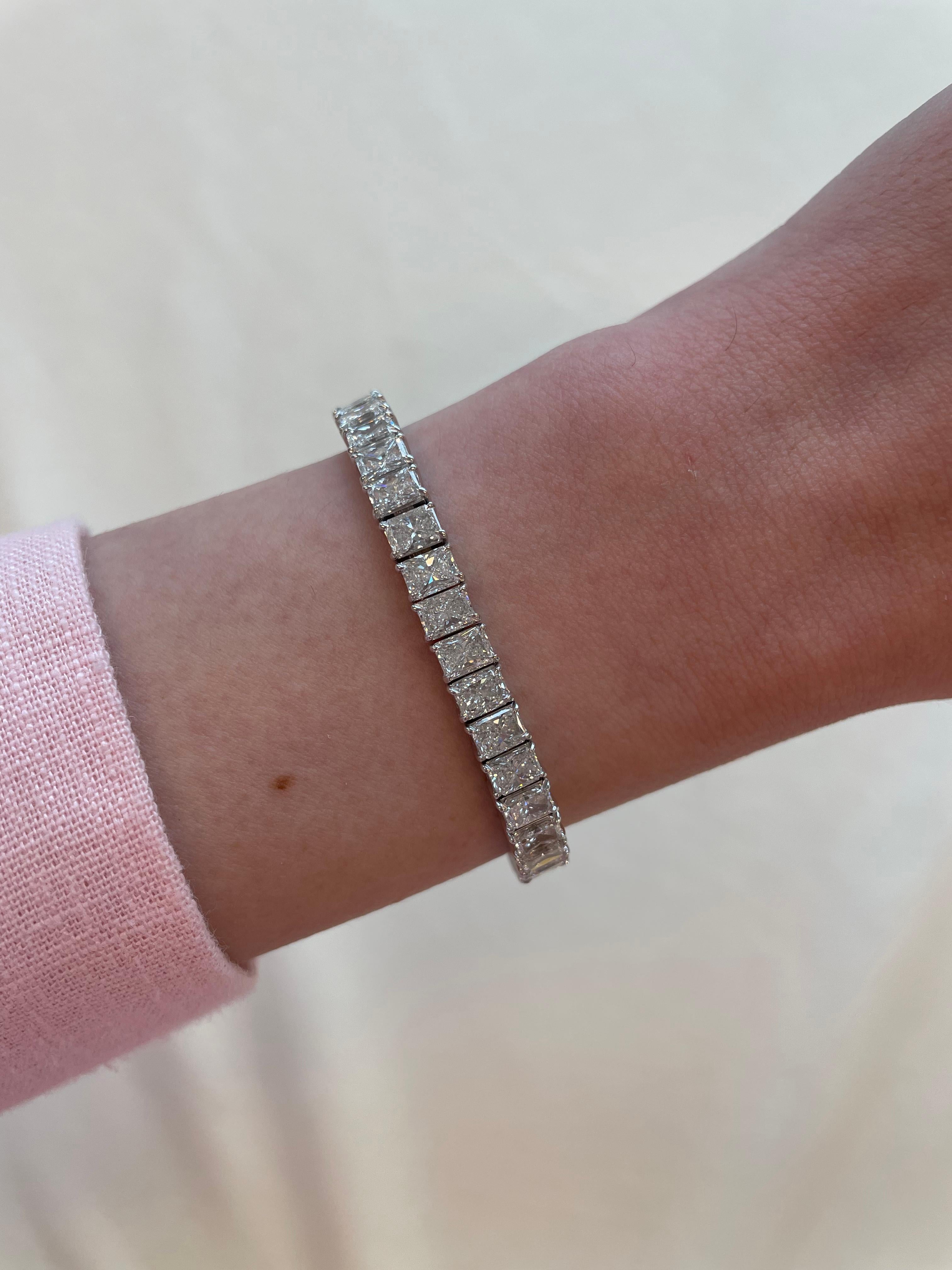 Stunning modern straight radiant cut diamond tennis bracelet. High jewelry by Alexander Beverly Hills.
46 radiant cut diamonds, 18.75 carats. Approximately E/F color and VVS clarity. 18k white gold, 24.49 grams.
Accommodated with an up to date