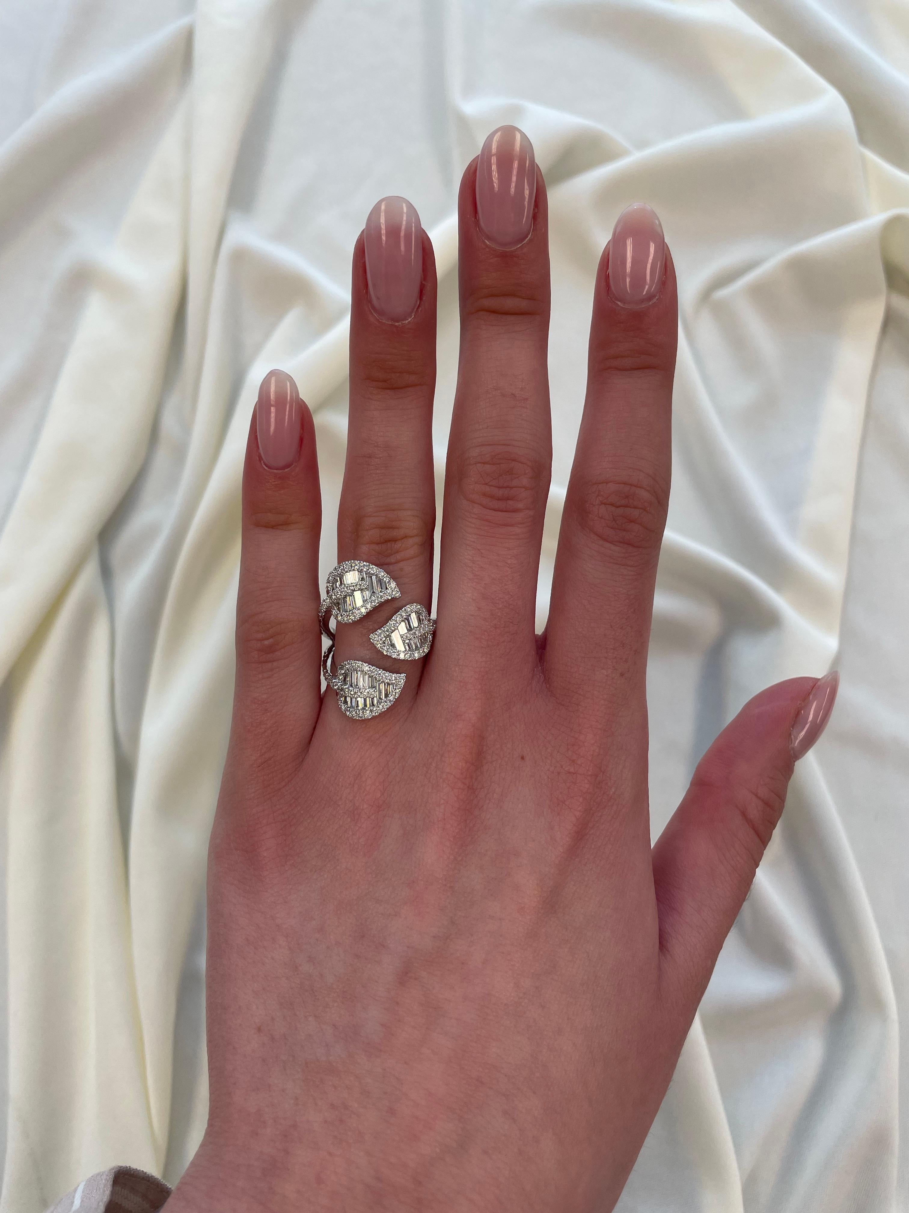 Stunning modern leaf motif bypass ring, by Alexander Beverly Hills.
141 round and baguette cut diamonds, 1.88 carats. Approximately G/H color grade and VS clarity grade. 18-karat white gold, 7.61 grams, current ring size 7.
Accommodated with an
