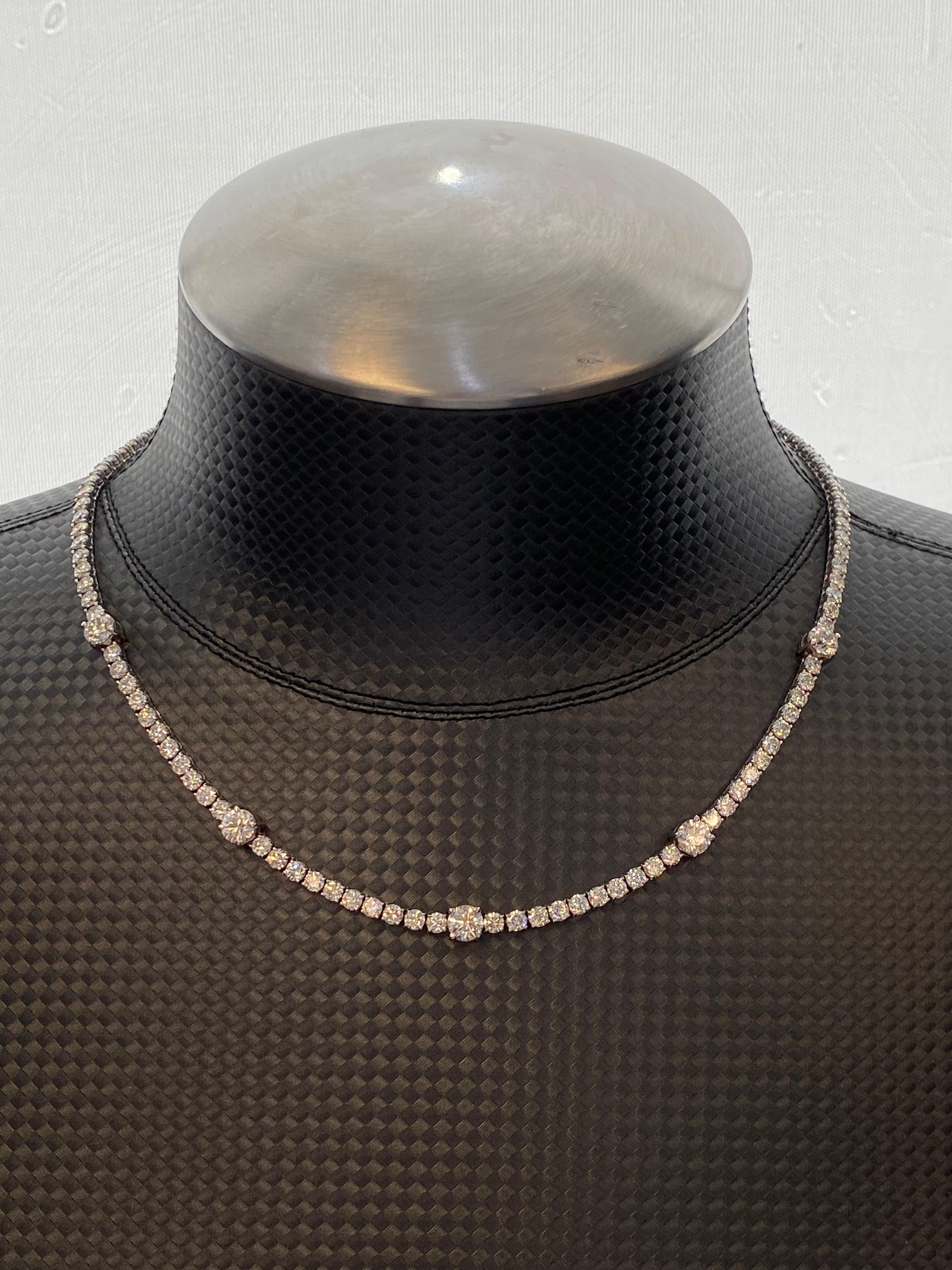 Exquisite and timeless diamonds tennis necklace. Created by Alexander of Beverly Hills.
123 round brilliant diamonds, 18.29 carats total. Five larger diamonds, averaging 0.72ct each. Approximately G/H color and VS clarity. Four prong set in 18k