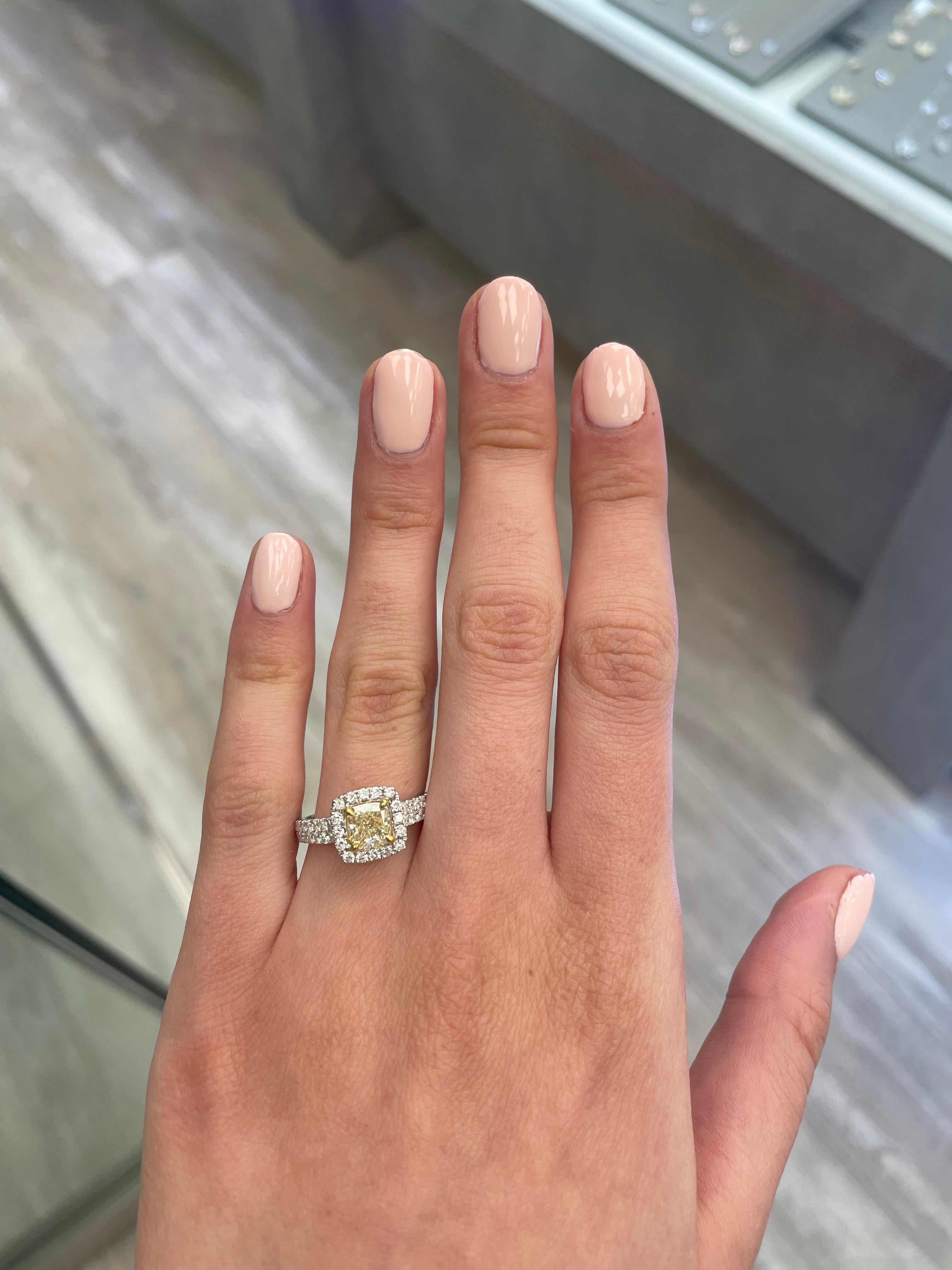 Stunning modern EGL certified yellow diamond with halo ring, two-tone 18k yellow and white gold. By Alexander Beverly Hills
1.90 carats total diamond weight.
1.21 carat cushion cut Fancy Yellow color and VS1 clarity diamond, EGL graded. Complimented