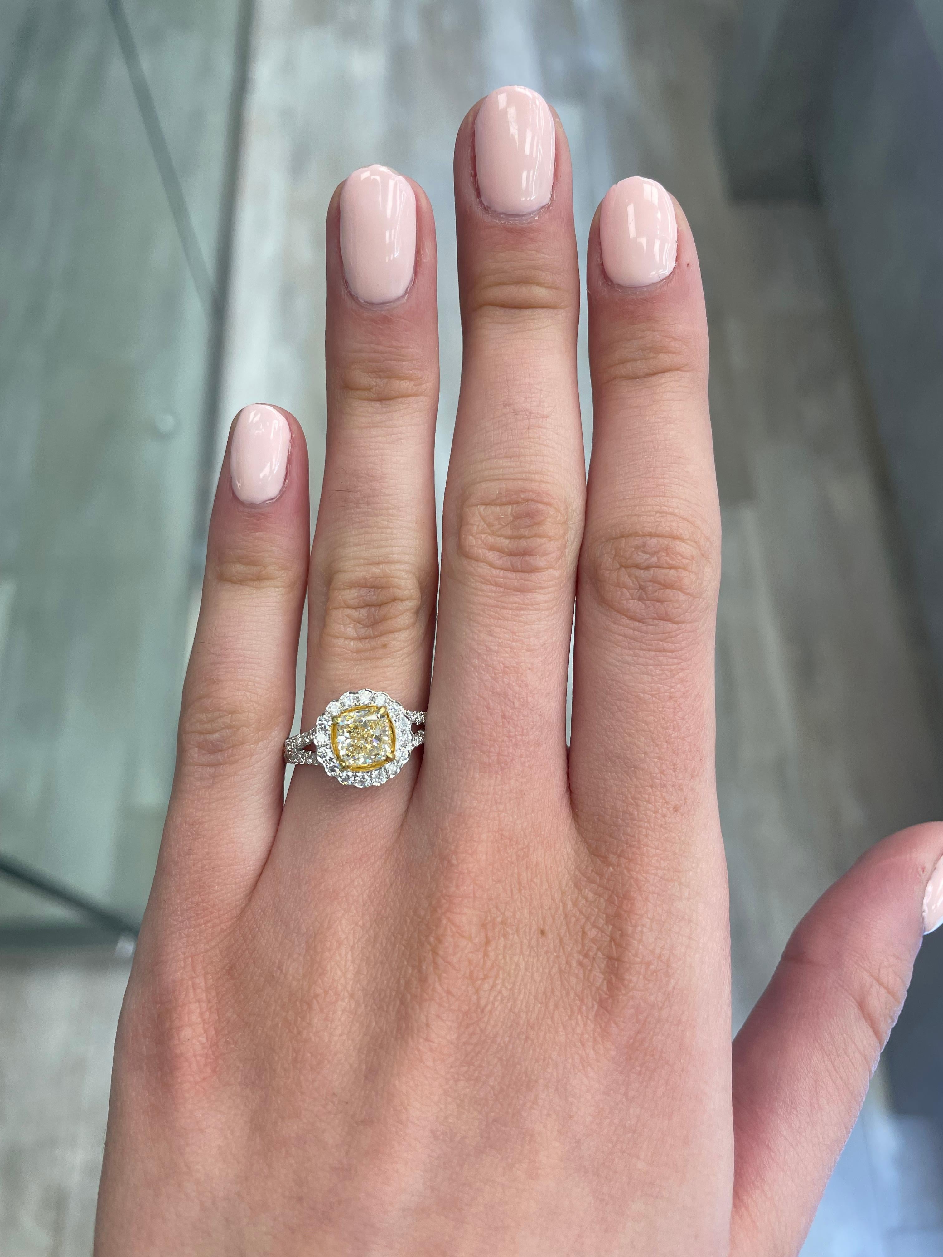 Stunning modern EGL certified yellow diamond with halo ring, two-tone 18k yellow and white gold, split shank. By Alexander Beverly Hills
1.93 carats total diamond weight.
1.37 carat cushion cut Fancy Light Yellow color and VVS2 clarity diamond, EGL