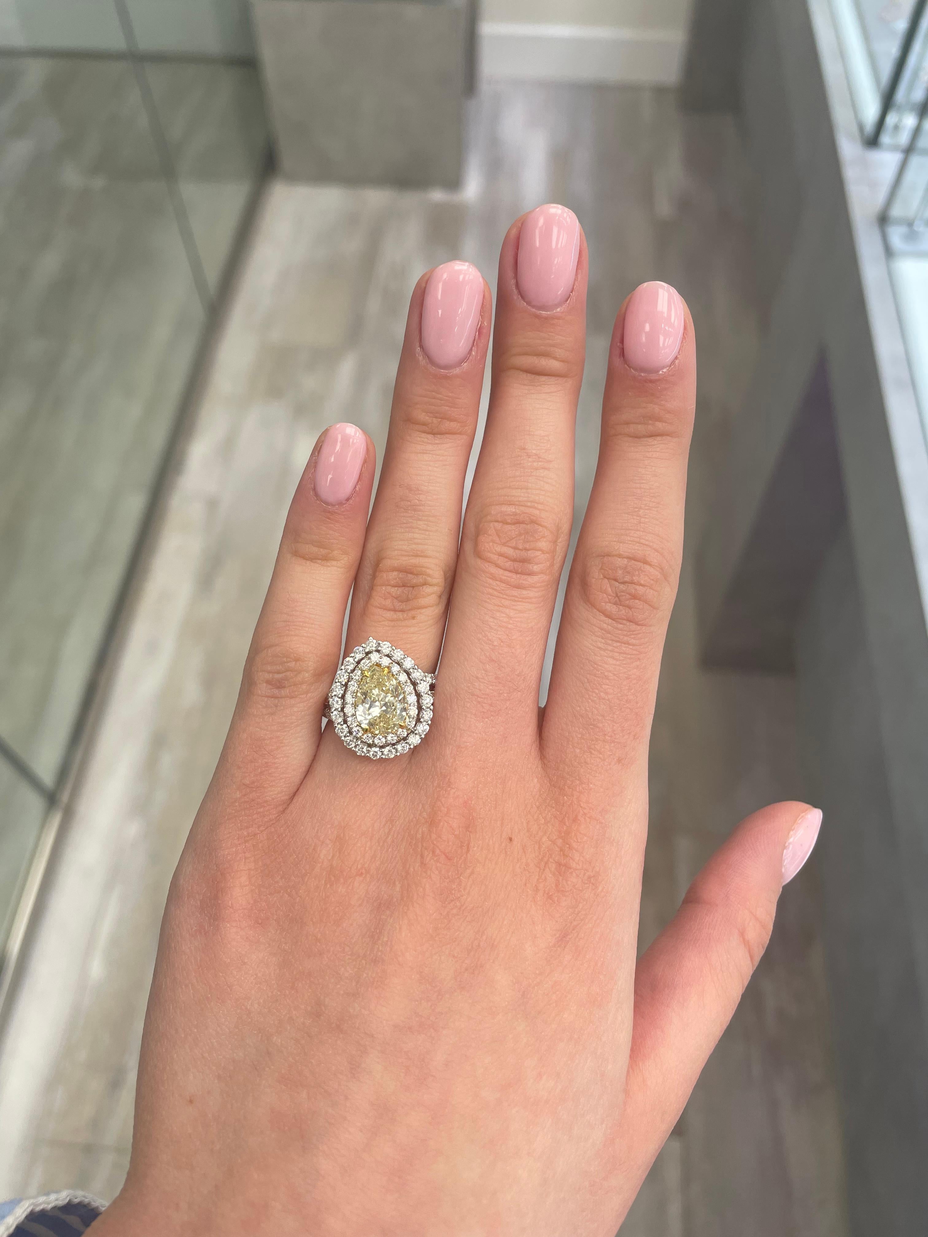 Stunning modern EGL certified yellow diamond double halo ring, two-tone 18k yellow and white gold. By Alexander Beverly Hills
3.32 carats total diamond weight.
2.01 carat pear cut Fancy Yellow color and SI2 clarity diamond, EGL graded in the