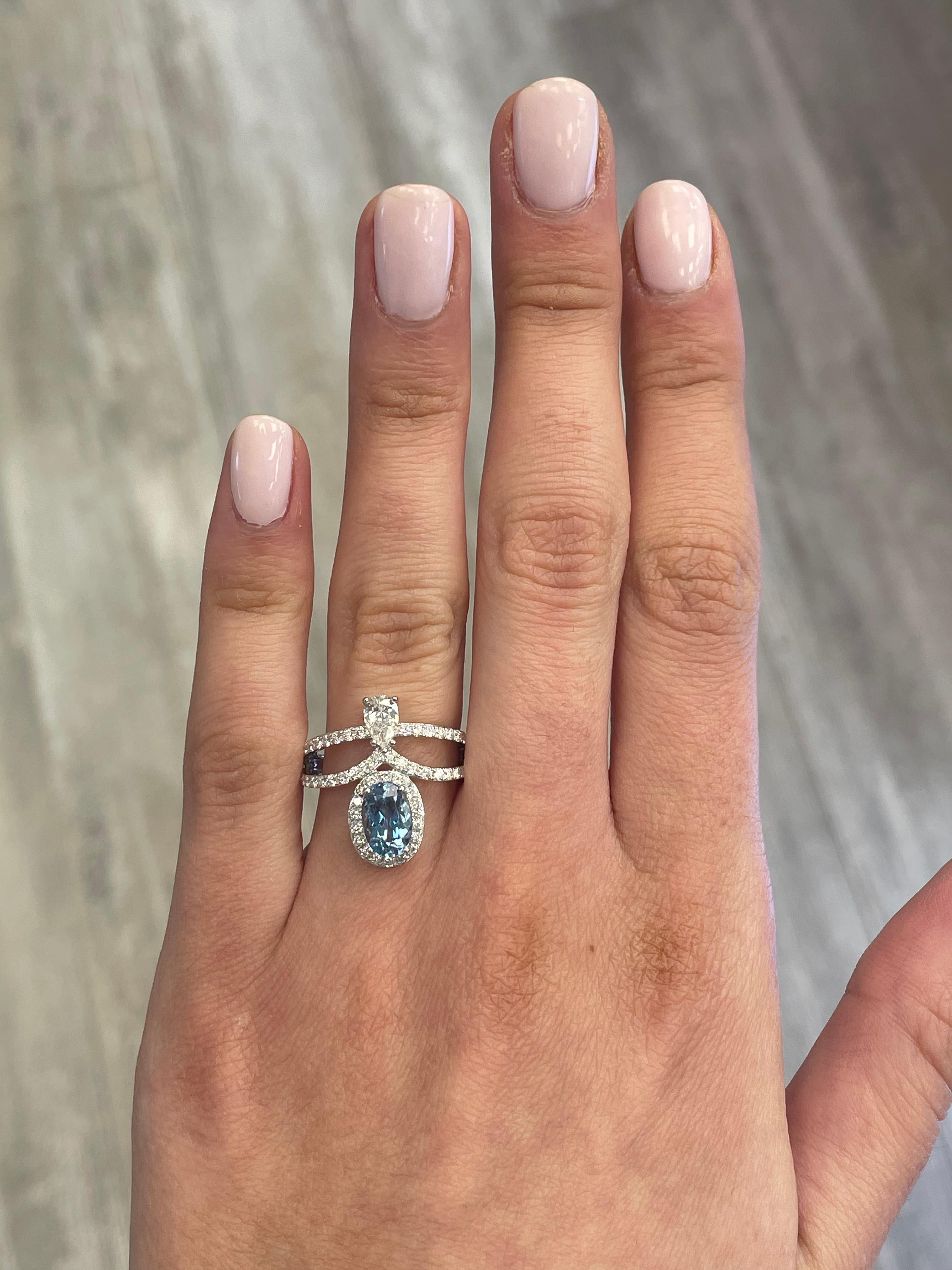 Stunning aquamarine and diamond ring, by Alexander Beverly Hills.
1 oval aquamarine, 1.08 carats. 1 pear shape diamonds, 0.34 carats, approximately G/H color and VS clarity. Complimented by 58 round brilliant diamonds, 0.60 carats. Approximately D-F