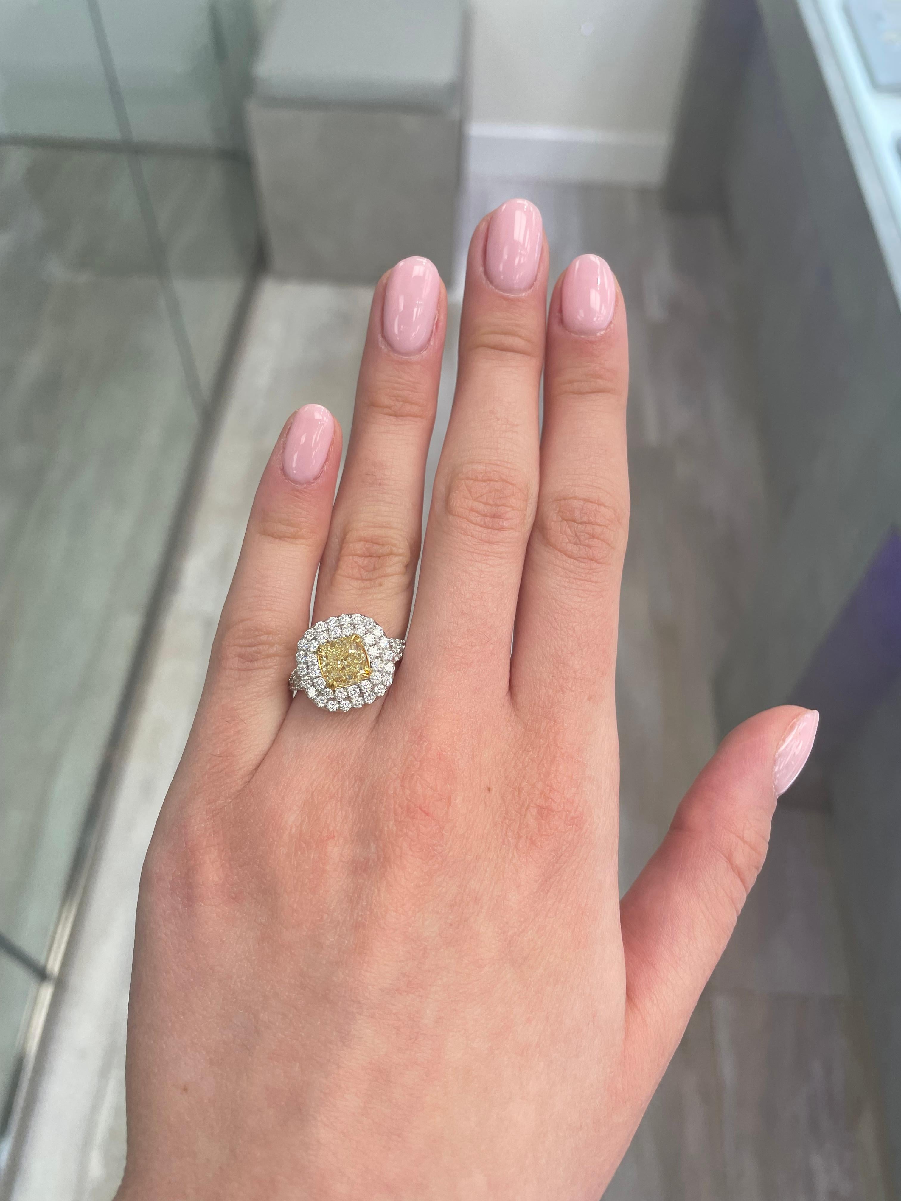 Stunning modern EGL certified yellow diamond double halo ring, two-tone 18k yellow and white gold. By Alexander Beverly Hills
3.19 carats total diamond weight.
2.02 carat cushion cut Fancy Intense Yellow color and VS2 clarity diamond, EGL graded in