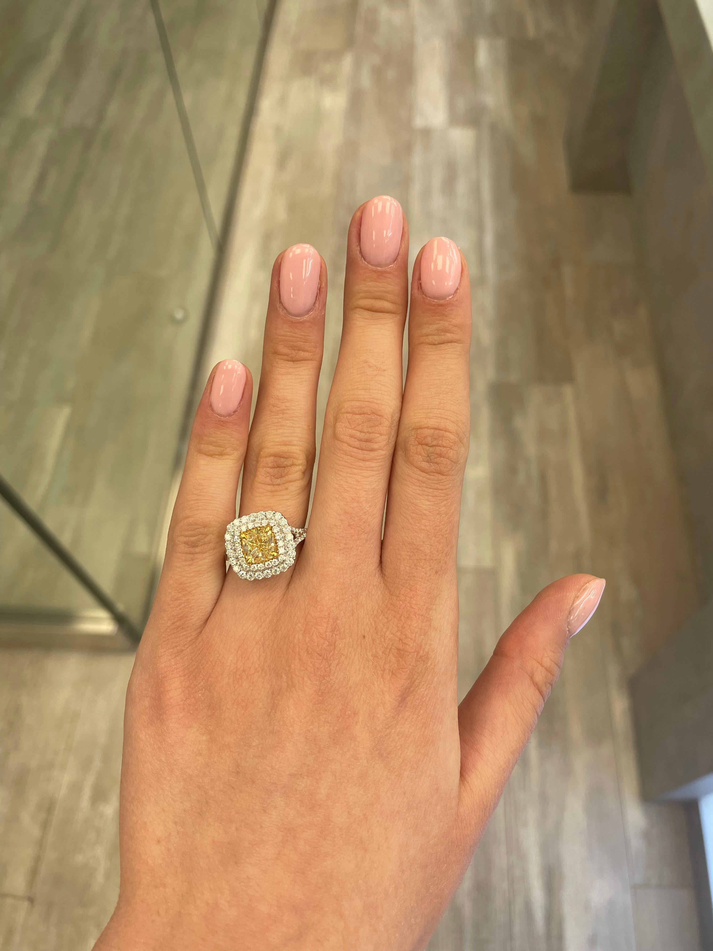 Stunning modern EGL certified yellow diamond double halo ring, two-tone 18k yellow and white gold. By Alexander Beverly Hills
2.97 carats total diamond weight.
2.02 carat cushion cut Fancy Intense Yellow color and VS2 clarity diamond, EGL graded in