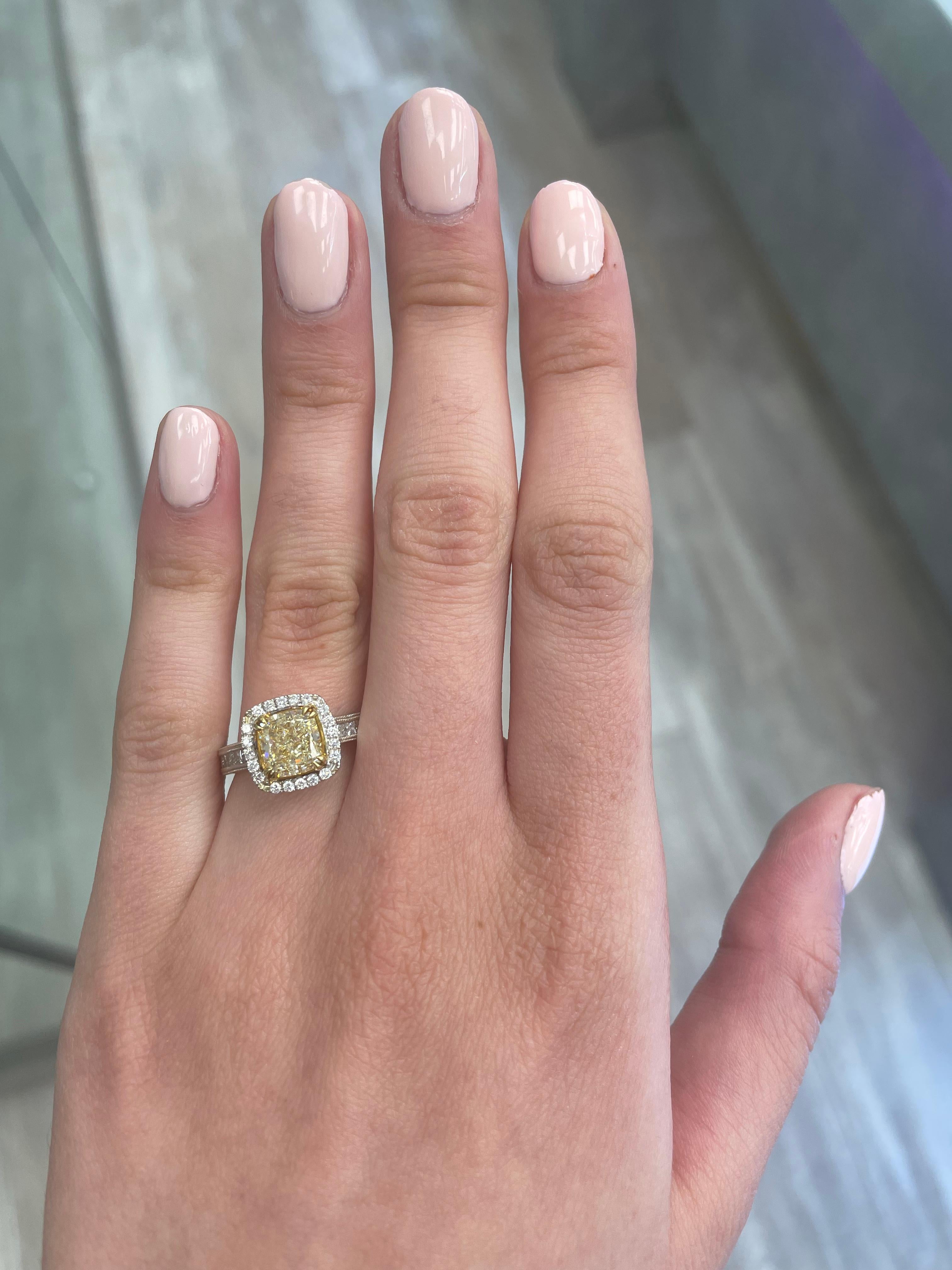 Stunning modern EGL certified yellow diamond with halo ring, two-tone 18k yellow and white gold, twisted shank. By Alexander Beverly Hills
2.61 carats total diamond weight.
2.03 carat cushion cut Fancy Intense Yellow color and SI1 clarity diamond,