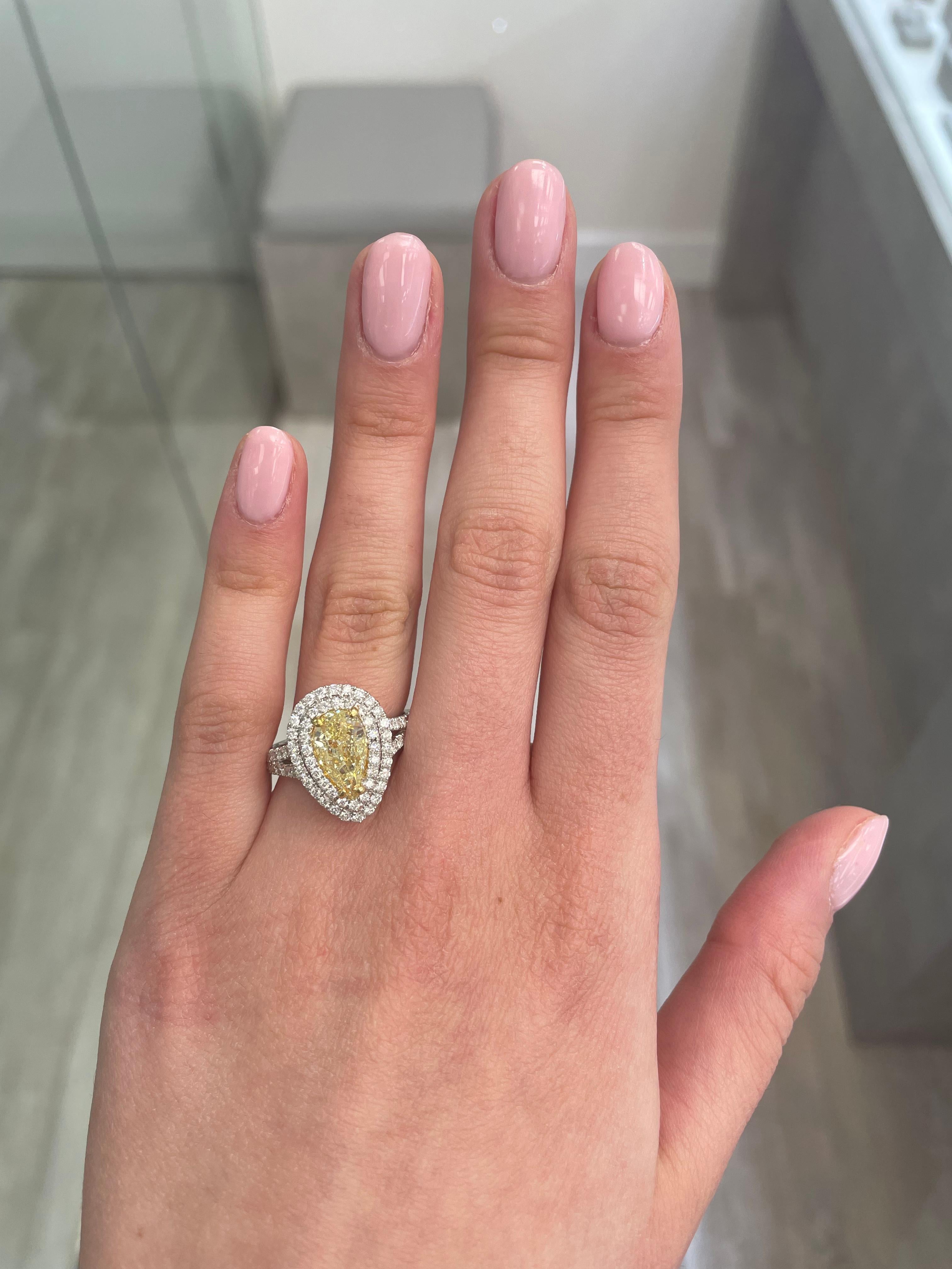 Stunning modern EGL certified yellow diamond double halo ring, two-tone 18k yellow and white gold. By Alexander Beverly Hills
3.07 carats total diamond weight.
2.04 carat pear cut Fancy Yellow color and SI2 clarity diamond, EGL graded in the