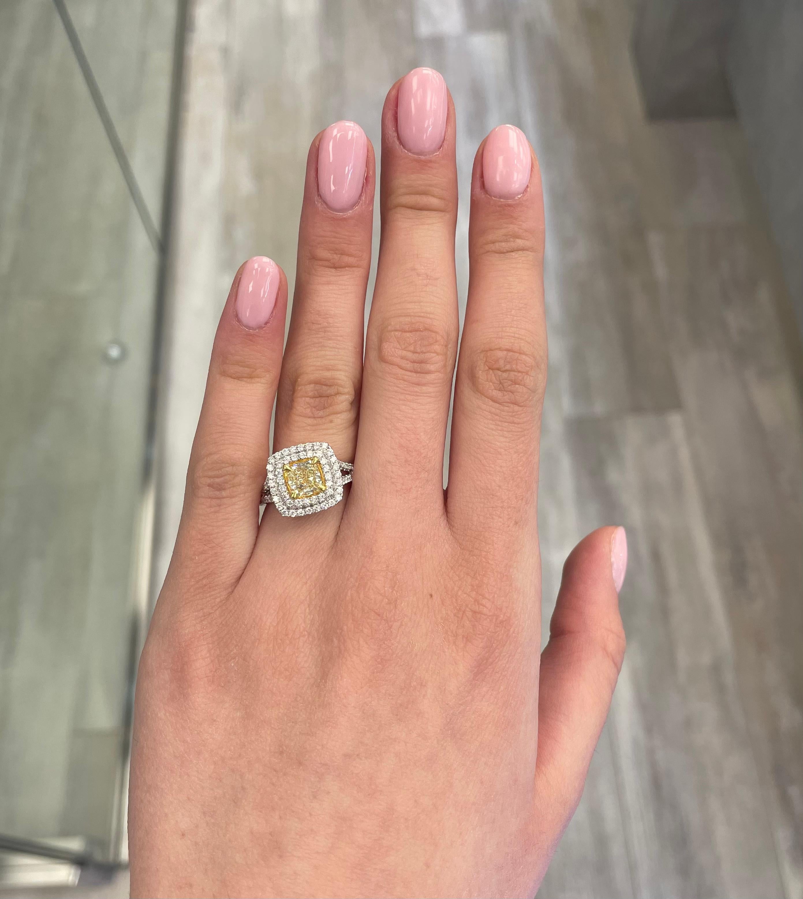 Stunning modern EGL certified fancy yellow diamond double halo ring, two-tone 18k yellow and white gold, split shank. By Alexander Beverly Hills
2.05 carats total diamond weight.
1.23 carat cushion cut Fancy Yellow color and VS1 clarity diamond, EGL