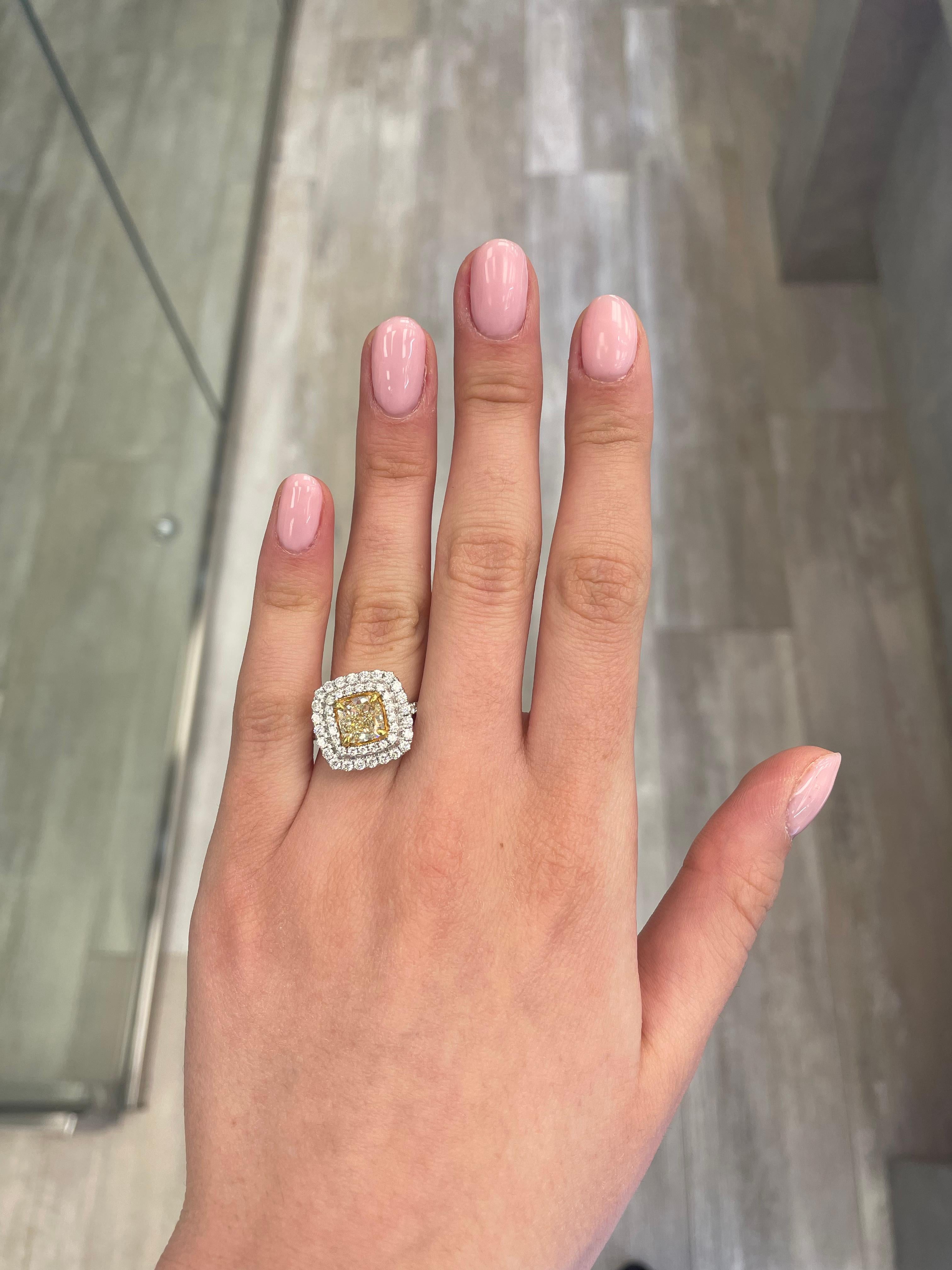 Stunning modern EGL certified yellow diamond double halo ring, two-tone 18k yellow and white gold. By Alexander Beverly Hills
3.08 carats total diamond weight.
2.05 carat cushion cut Fancy Yellow color and VS1 clarity diamond, EGL graded in the