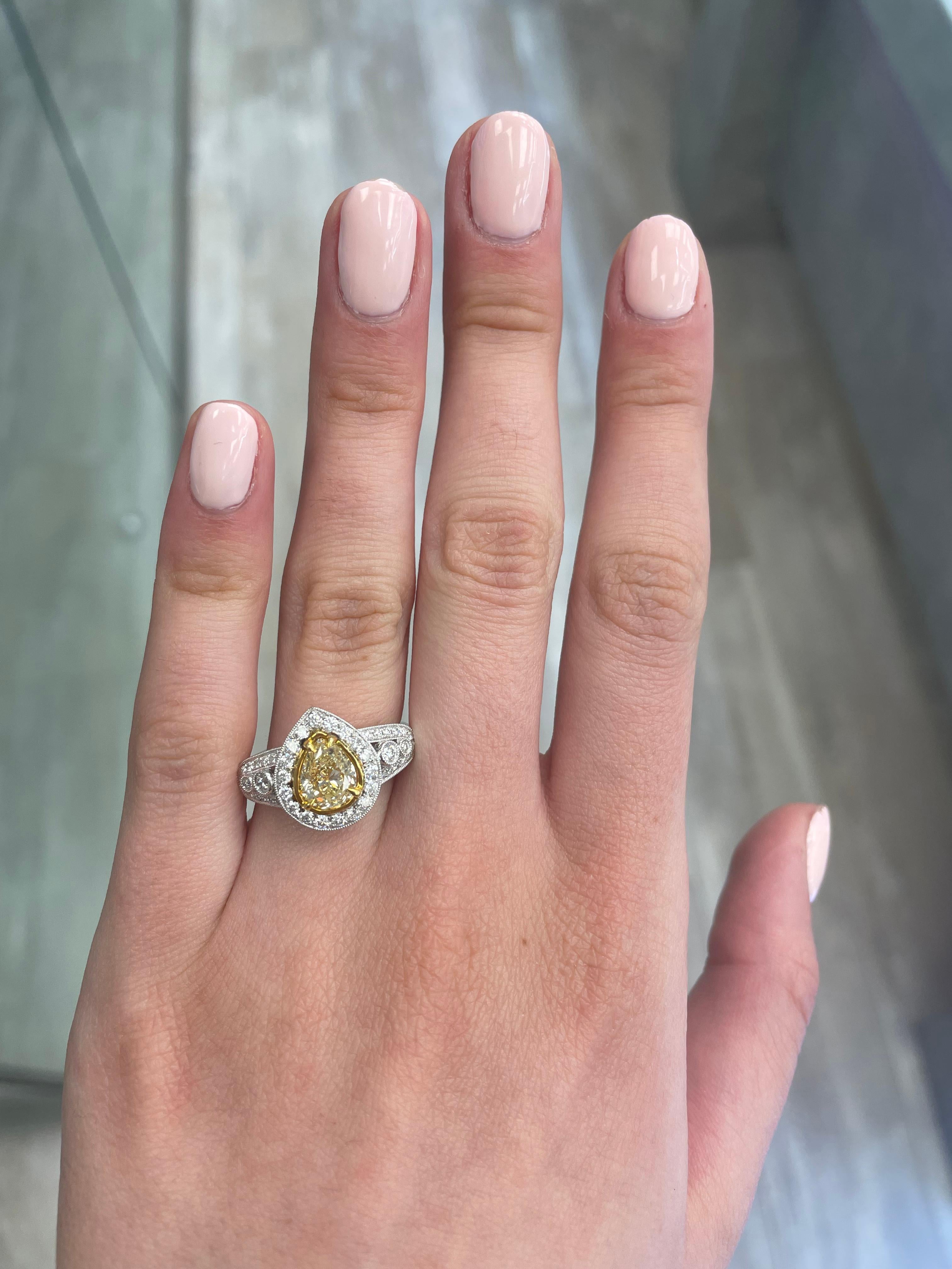 Stunning modern EGL certified yellow diamond with halo ring, two-tone 18k yellow and white gold. By Alexander Beverly Hills
2.06 carats total diamond weight.
1.51 carat cushion cut Fancy Yellow color and SI2 clarity diamond, EGL graded. Complimented