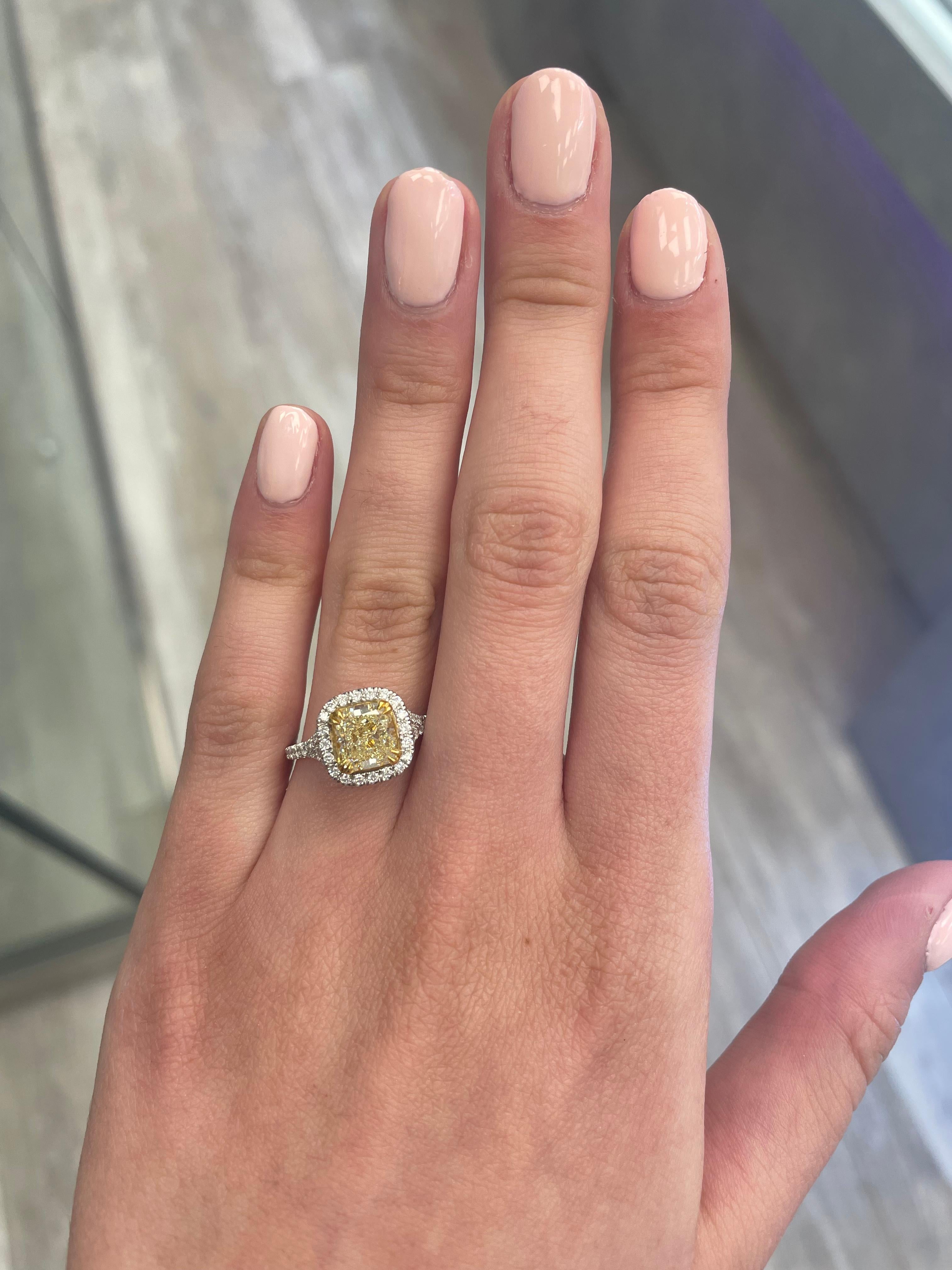 Stunning modern EGL certified yellow diamond with halo ring, two-tone 18k yellow and white gold, twisted shank. By Alexander Beverly Hills
2.48 carats total diamond weight.
2.07 carat cushion cut Fancy Intense Yellow color and VS1 clarity diamond,