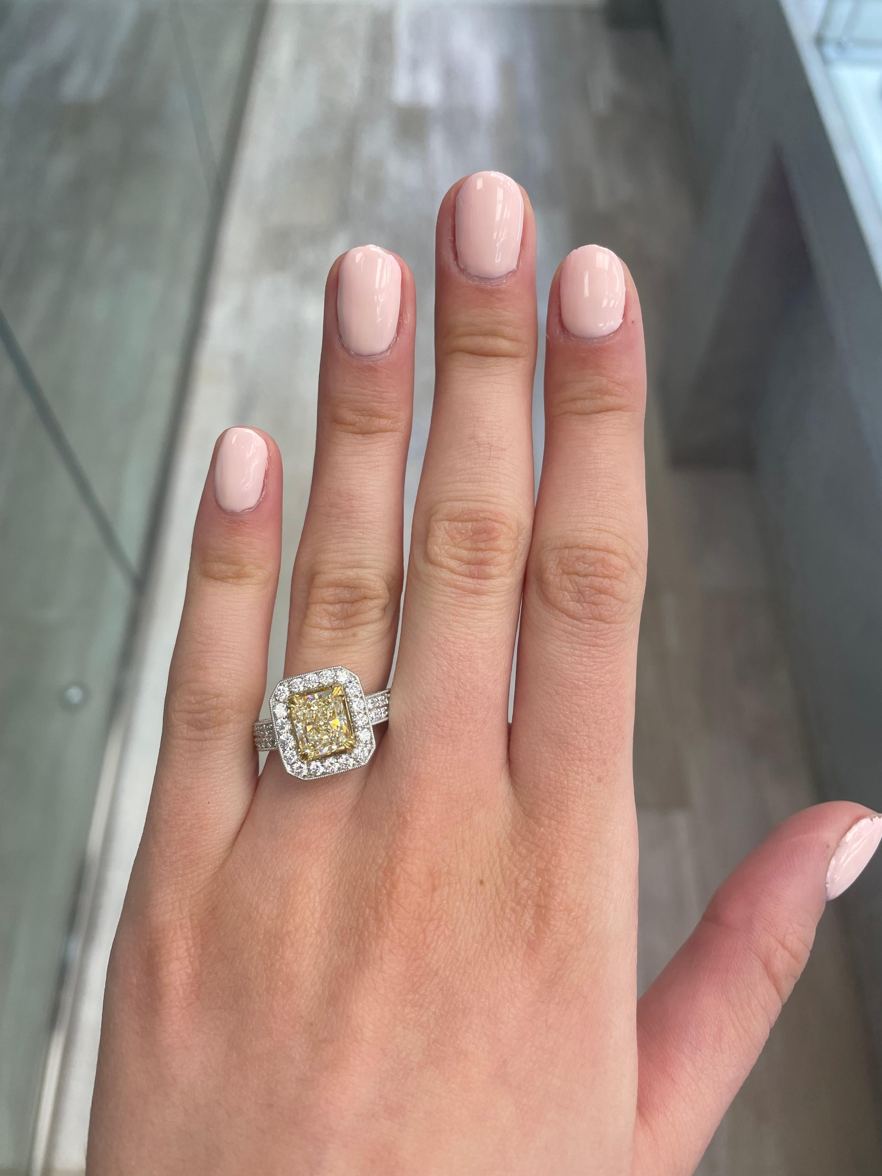 Stunning modern EGL certified yellow diamond with halo ring, two-tone 18k yellow and white gold. By Alexander Beverly Hills
3.49 carats total diamond weight.
2.08 carat radiant cut Fancy Yellow color and VVS2 clarity diamond, EGL graded.
