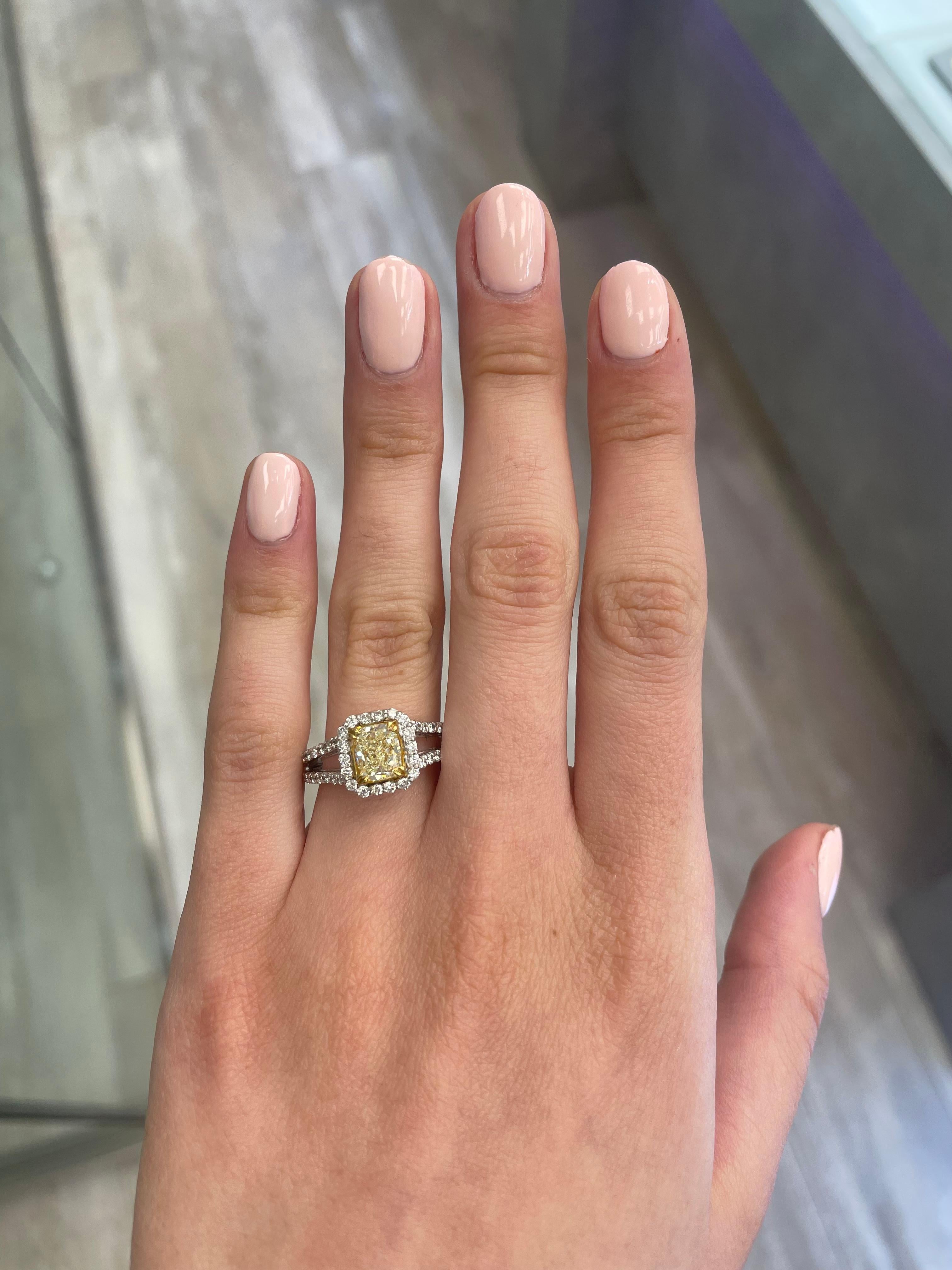 Stunning modern EGL certified yellow diamond with halo ring, two-tone 18k yellow and white gold. By Alexander Beverly Hills
2.08 carats total diamond weight.
1.36 carat cushion cut Fancy Yellow color and VS1 clarity diamond, EGL graded. Complimented