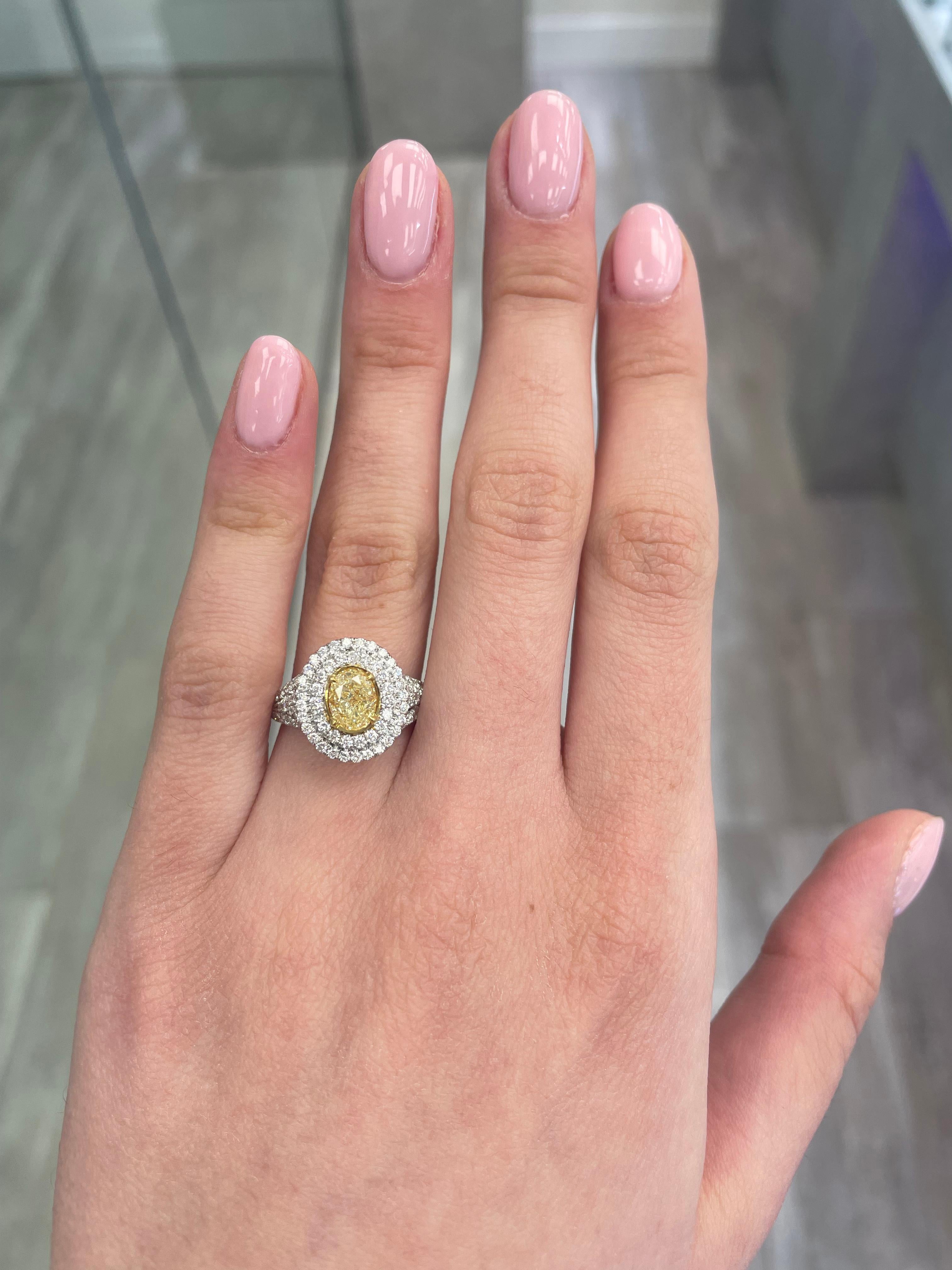 Stunning modern EGL certified yellow diamond double halo ring, two-tone 18k yellow and white gold. By Alexander Beverly Hills
2.10 carats total diamond weight.
1.05 carat oval cut Fancy Intense Yellow color and VS2 clarity diamond, EGL graded in the
