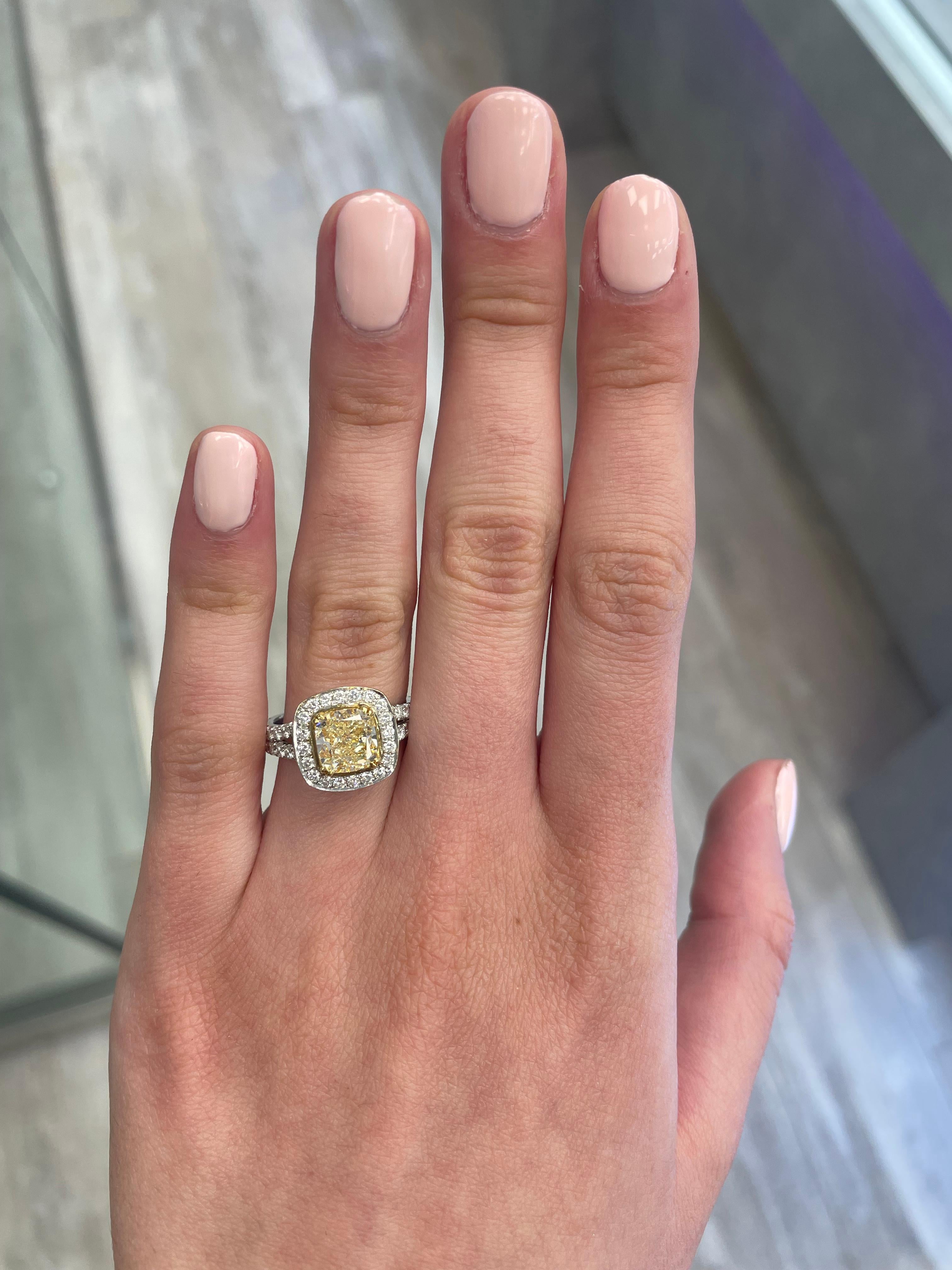 Stunning modern EGL certified yellow diamond with halo ring, two-tone 18k yellow and white gold, split shank. By Alexander Beverly Hills
3.12 carats total diamond weight.
2.11 carat cushion cut Fancy Intense Yellow color and VS1 clarity diamond, EGL