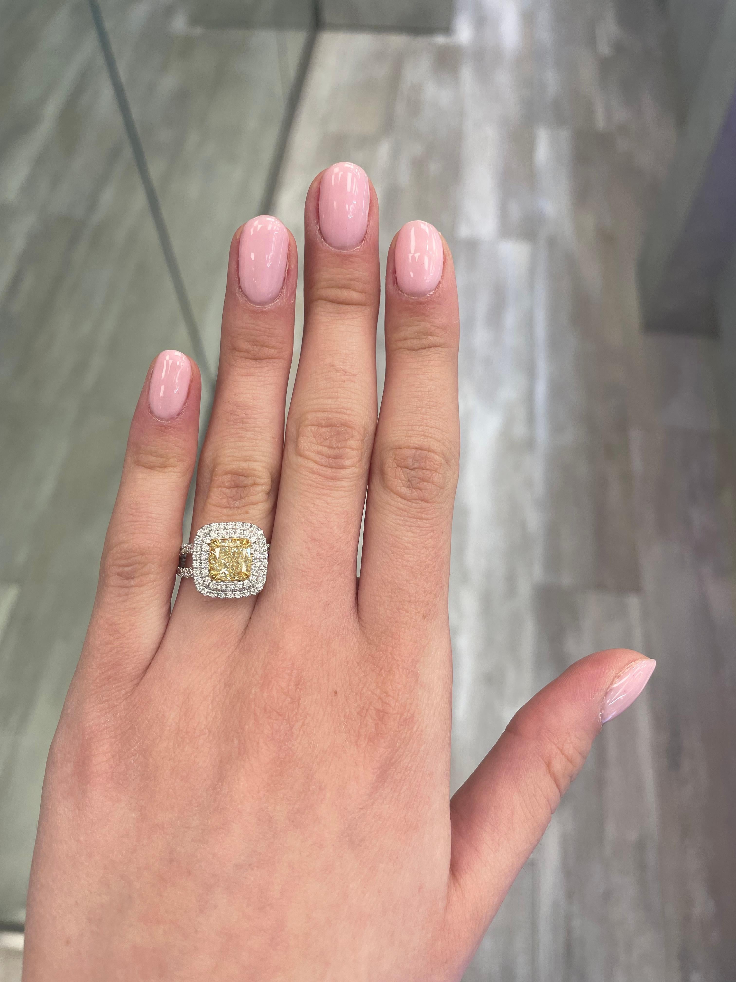 Stunning modern EGL certified yellow diamond double halo ring, two-tone 18k yellow and white gold. By Alexander Beverly Hills
3.01 carats total diamond weight.
2.11 carat cushion cut Fancy Intense Yellow color and VS2 clarity diamond, EGL graded in